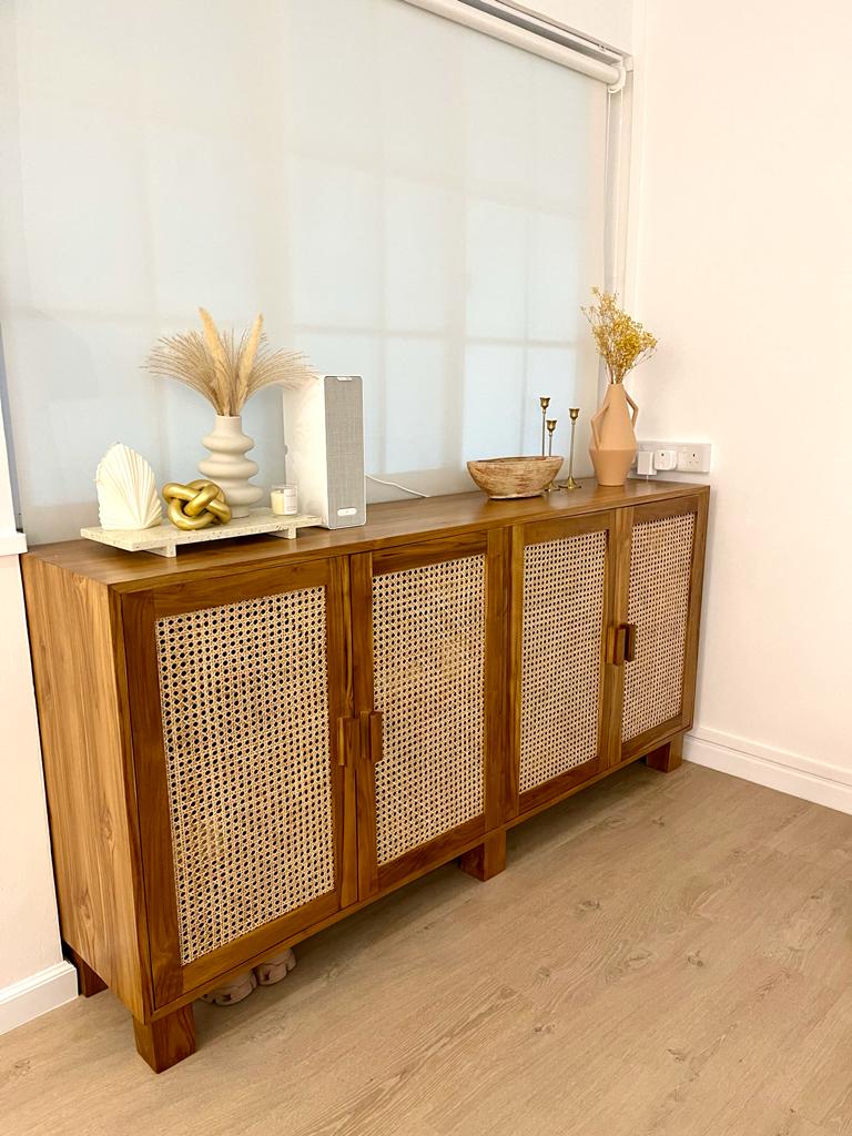 A tour in our Living Room - Wooden cabinet with woven design, light wooden floor, sheer window with blinds, decorative items