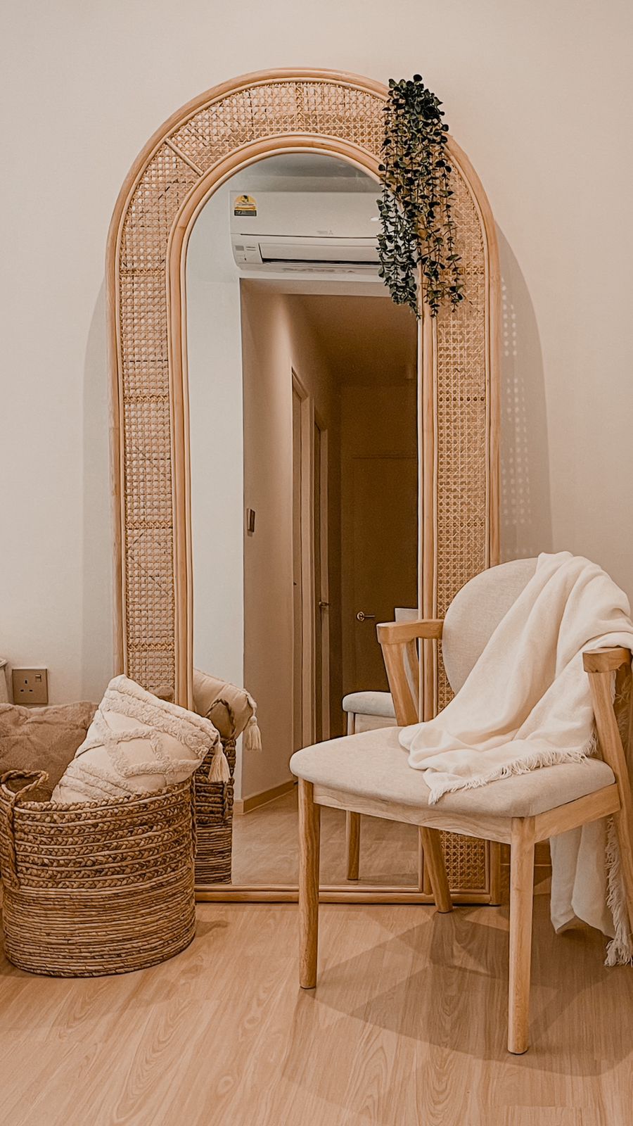 Bright & Airy Cosy Corner  - Woven bamboo mirror, cozy room, wooden furniture, beige chair, white blanket, indoor plant, soft