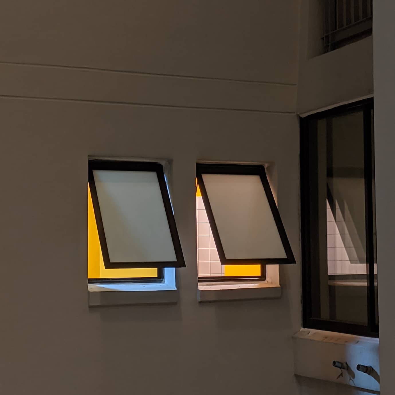 Sneak peek to Hominghumans - Modern architectural design, minimalist window frames, contrasting light and shadow, geometric