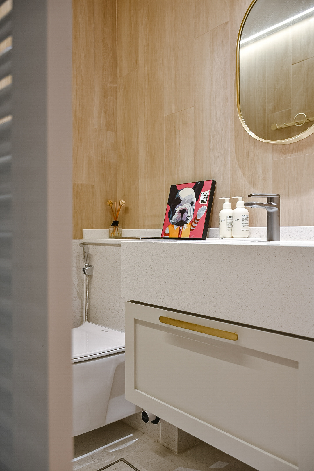 Bathroom Bliss: the Perfect Relaxation Space - Wooden wall, modern bathroom, white sink, gold handles, minimalist design