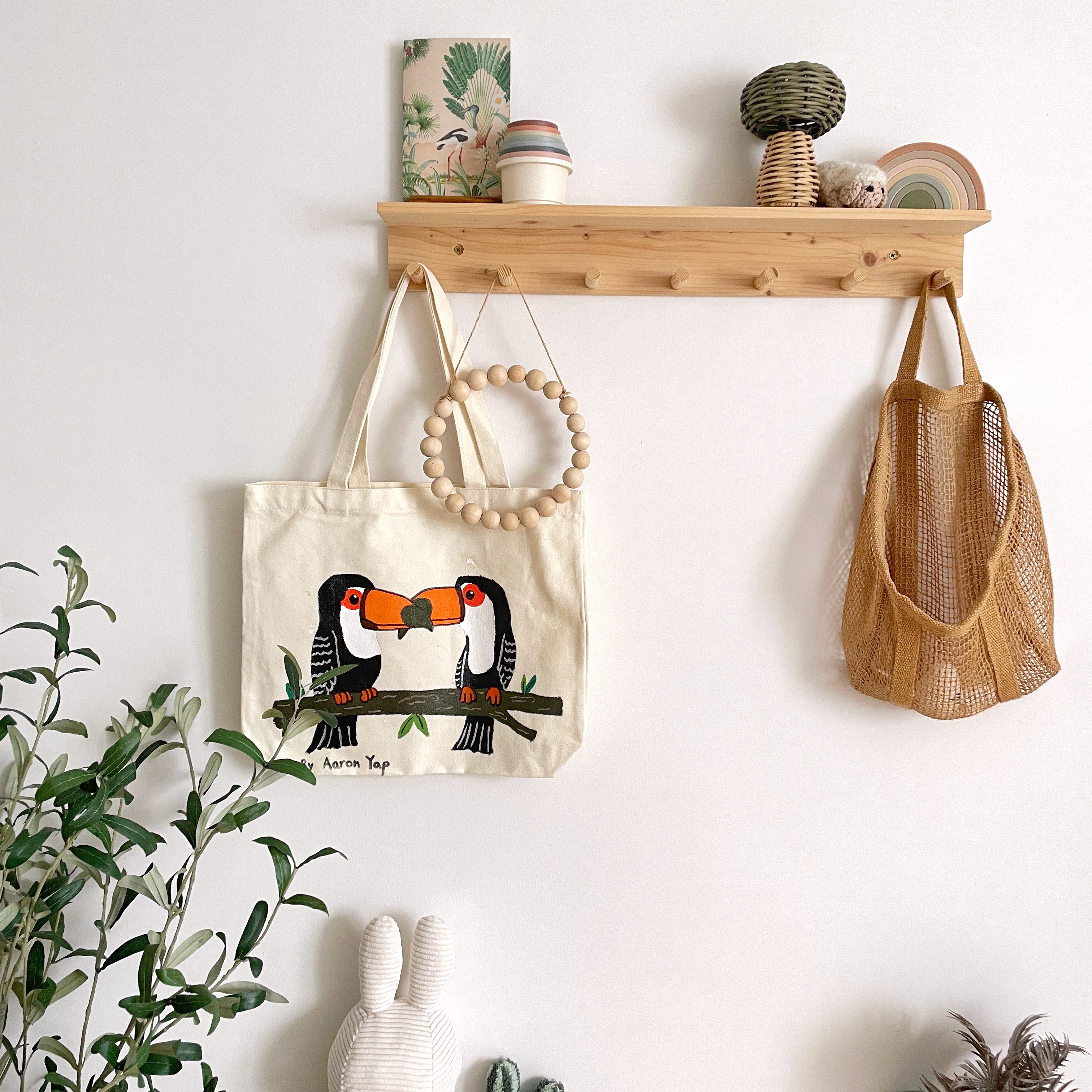 Calming and cheery nursery - vibrant botanical wall art, cozy indoor decor, natural elements, green plants, woven baskets