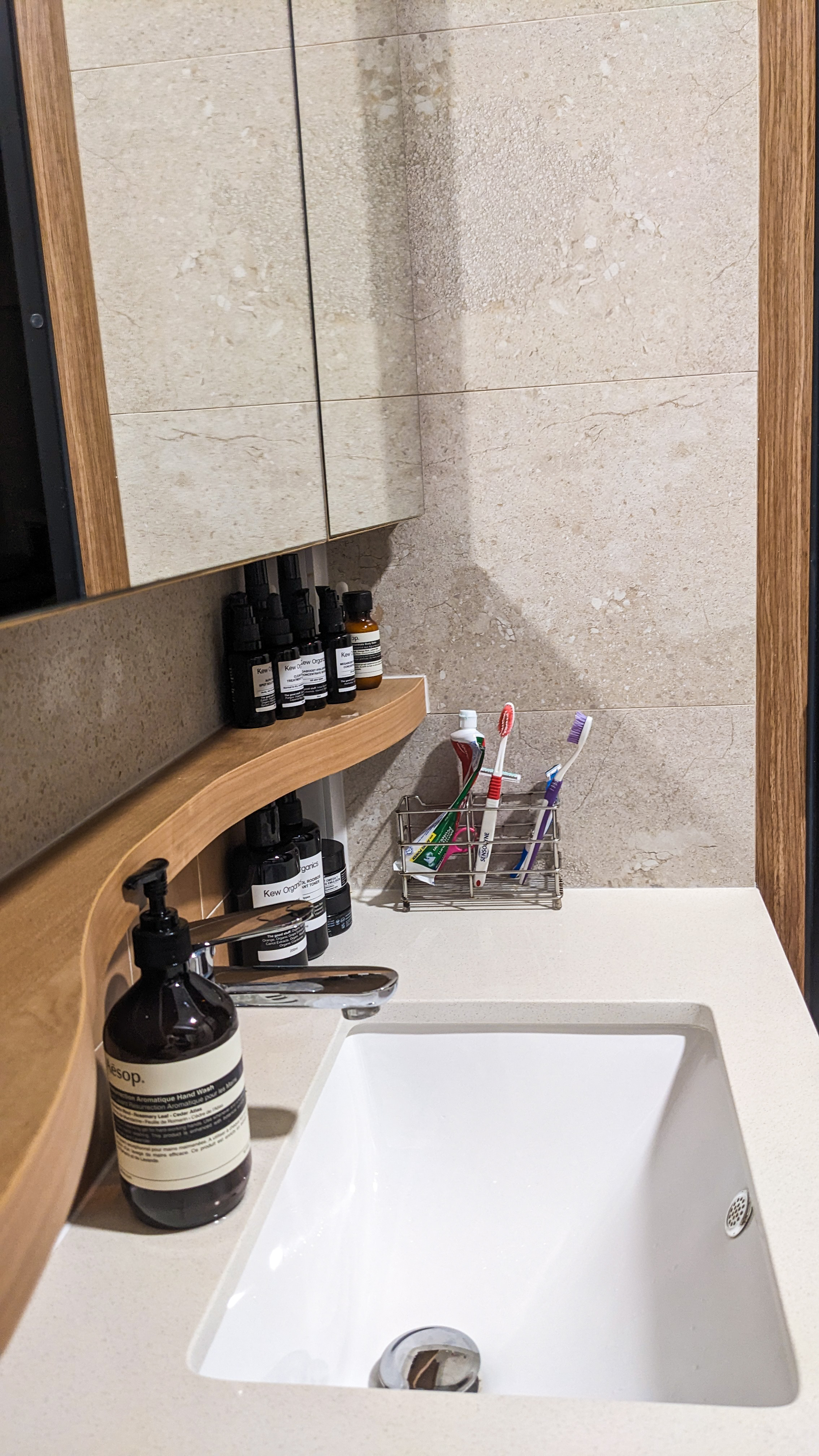 A Safe Haven | Skip to our Loo - Wooden shelf, black pump bottles, skincare products, hand soap, toothbrush holder