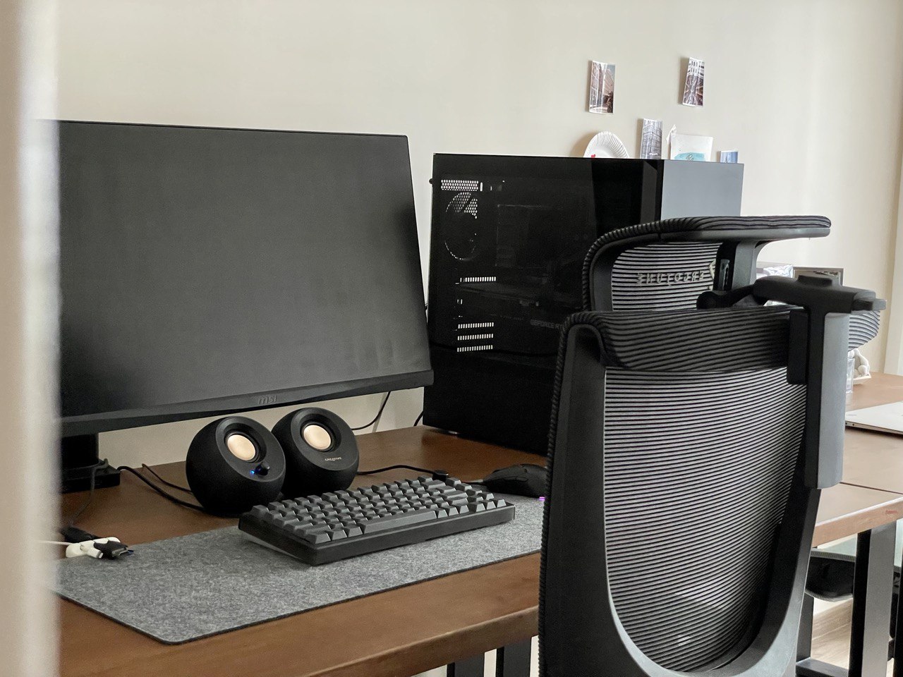 Study Room for All Things Studious  - Black computer desk, ergonomic chair, black computer monitor, dual speakers, black