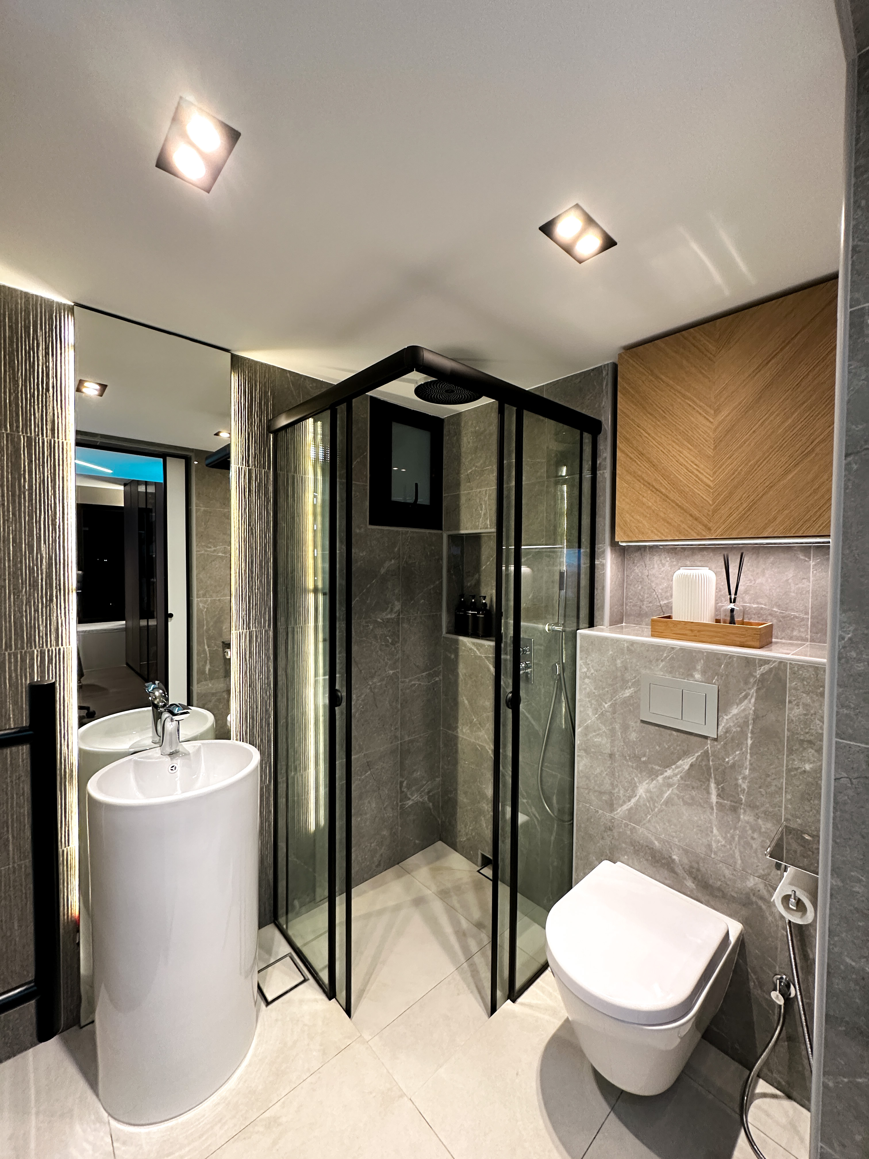 Hotel-like Luxe in a Home - Modern bathroom with sleek design, large mirror, glass shower enclosure, contemporary sink