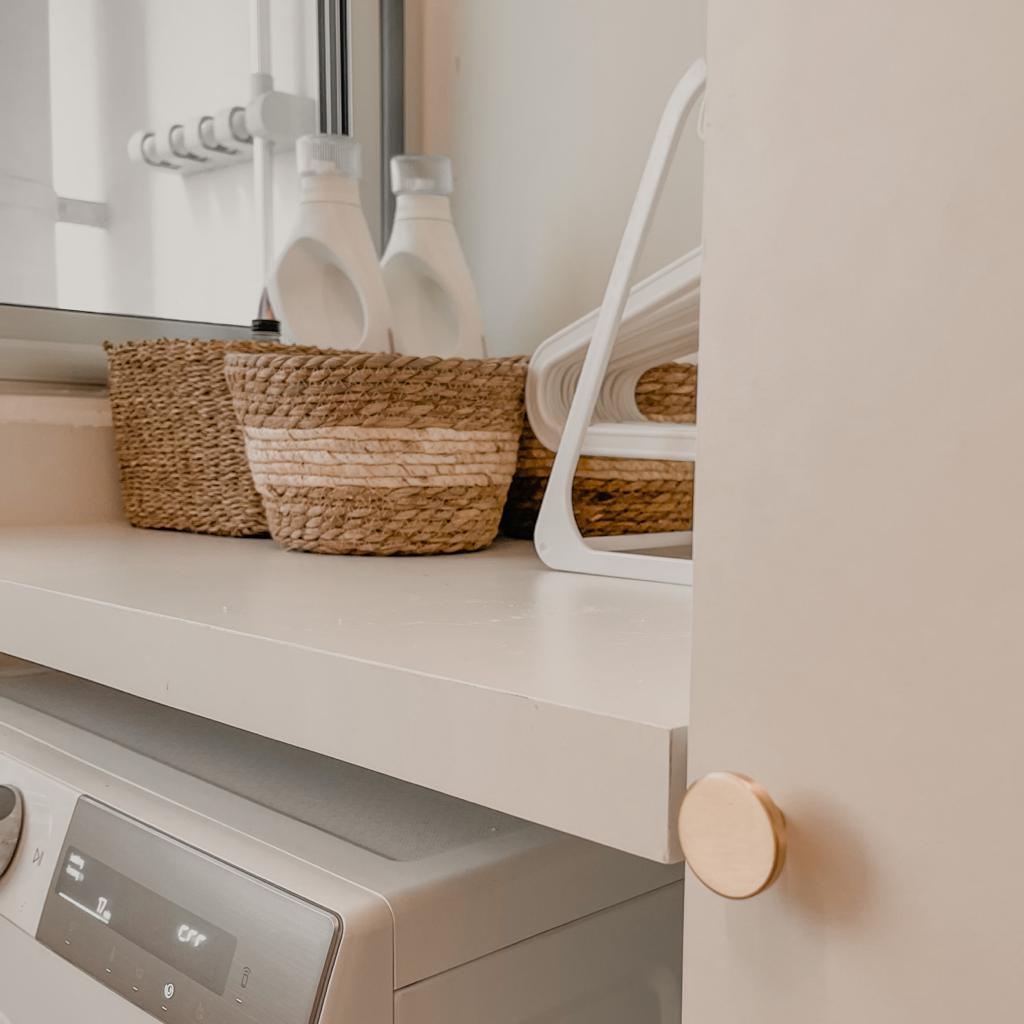 Minimalist & Clutter-Free Service Yard  - White kitchen countertop, modern appliances, laundry basket, woven baskets, white