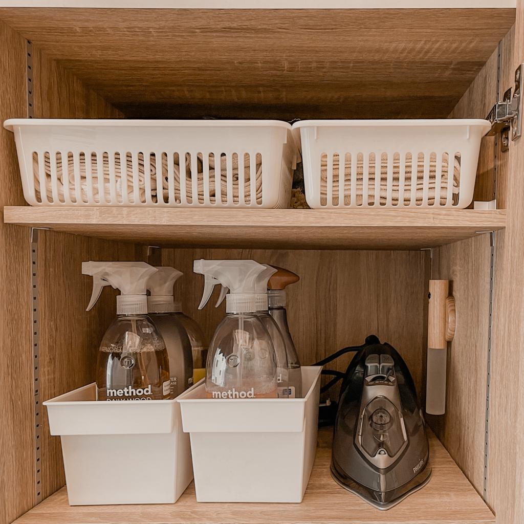 Minimalist & Clutter-Free Service Yard  - Wooden cabinet, neatly organized, white baskets, cleaning supplies, method brand