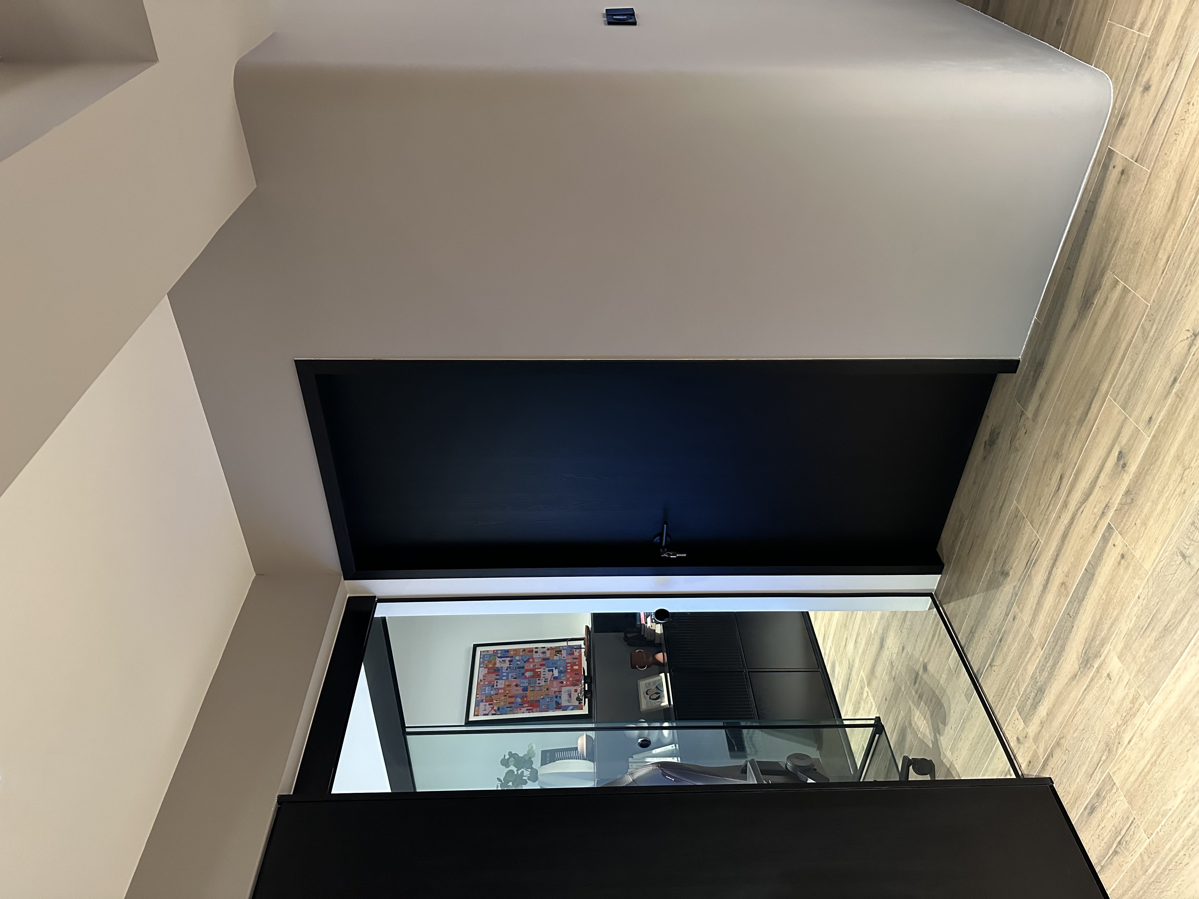 Entryway 🚪 - Modern minimalist interior, sleek black ceiling, wooden floor, geometric design, contemporary furniture, glass