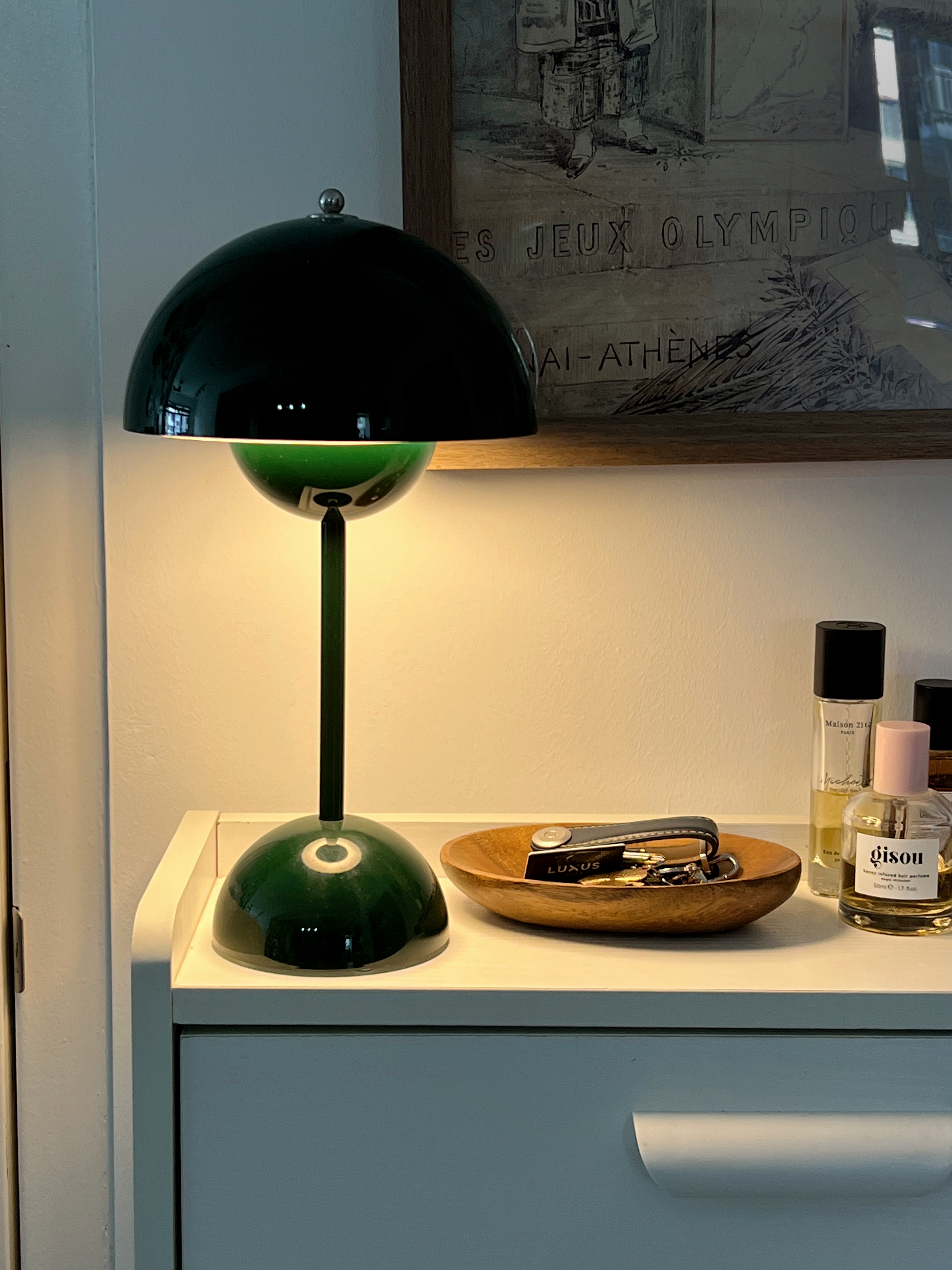 Our entryway of our 4 room BTO (No Carpentry) - Green lamp with black shade, wooden tray with jewelry, "Luxus" perfume