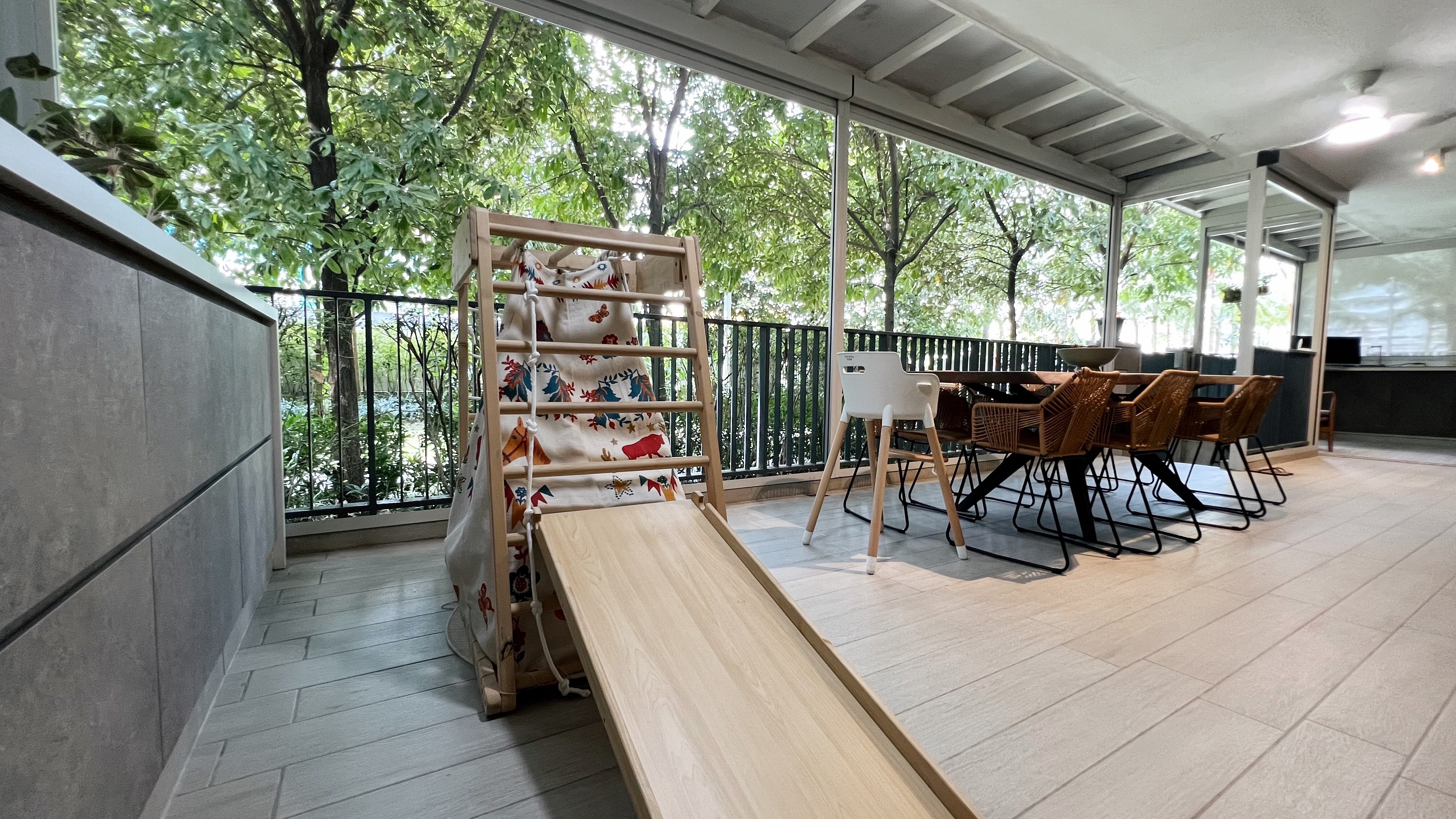 1260sqft ground floor unit with a garden view! - Wooden play structure with colorful fabric slide on balcony, Outdoor dining