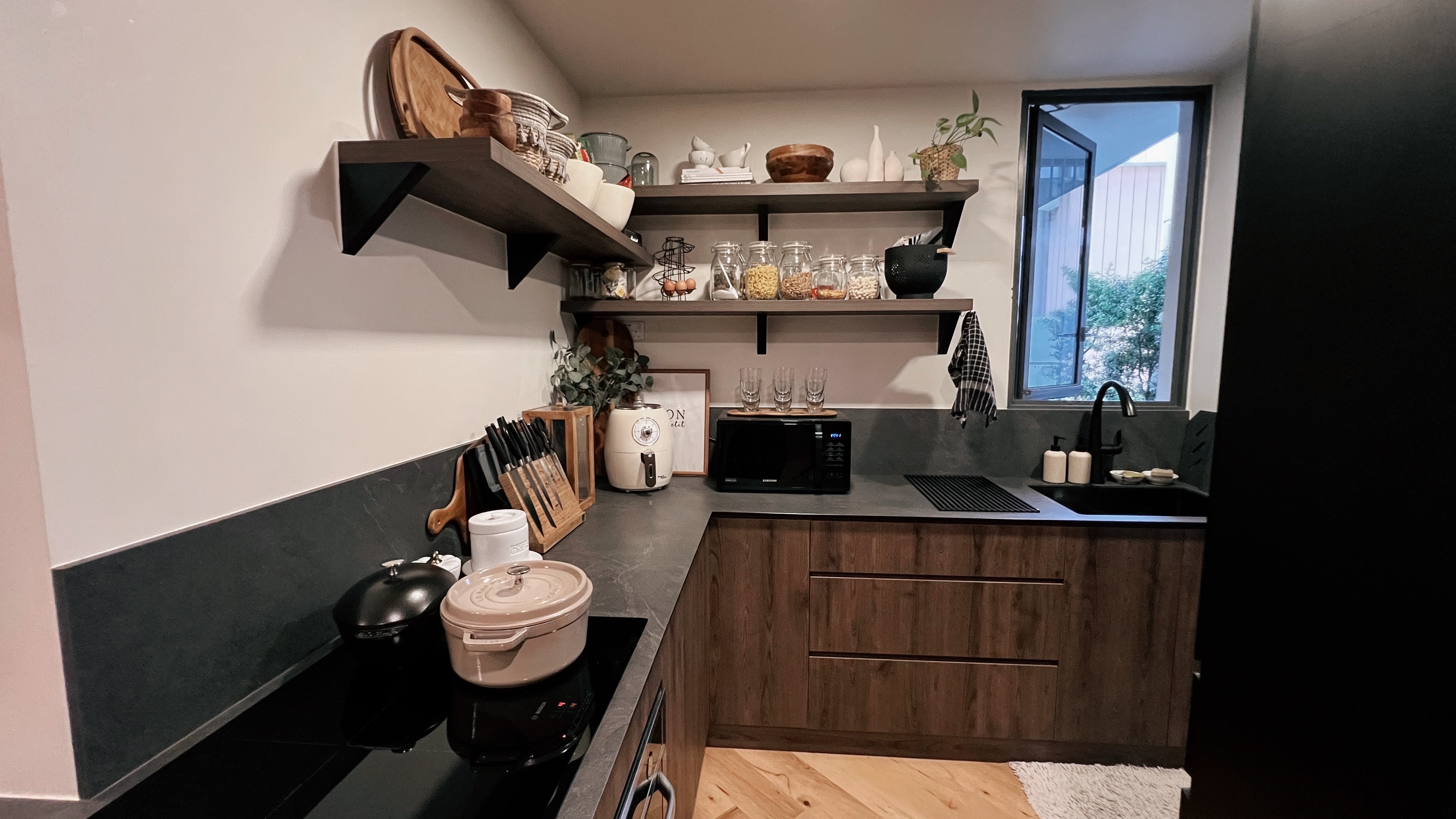 1260sqft ground floor unit with a garden view! - Wooden kitchen shelves, modern kitchen design, dark countertops, black