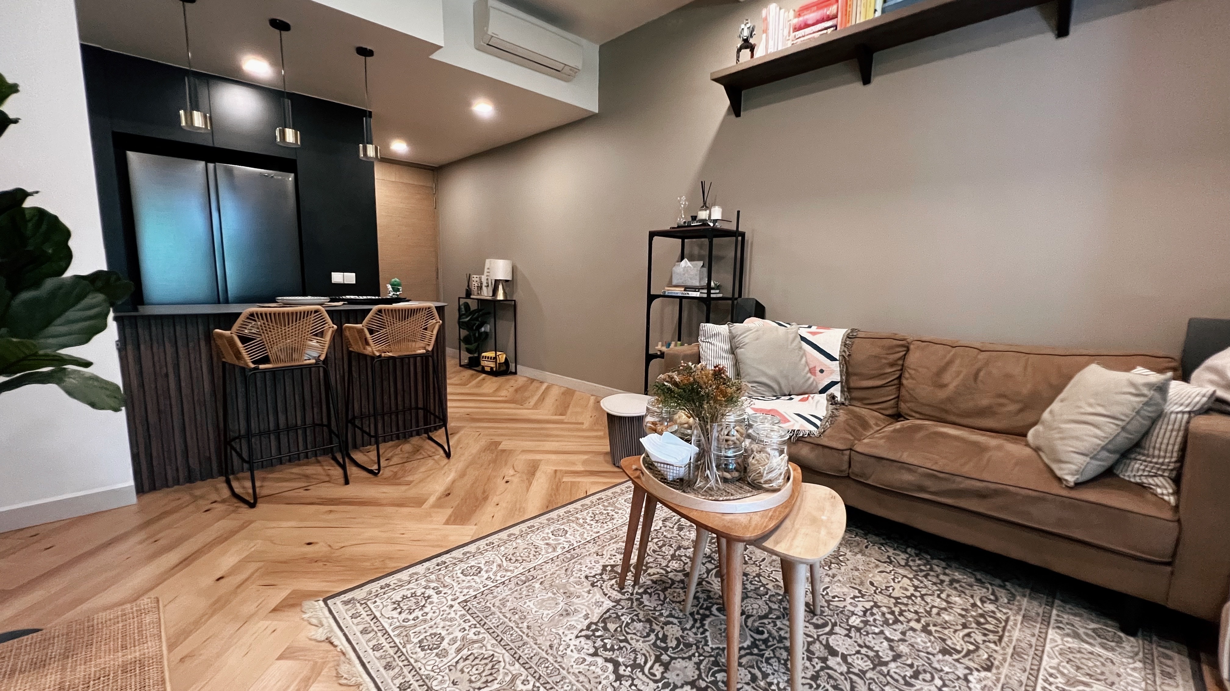 A living room refresh for Hari Raya! - Modern living room with wooden herringbone floor, sleek kitchen with black cabinetry