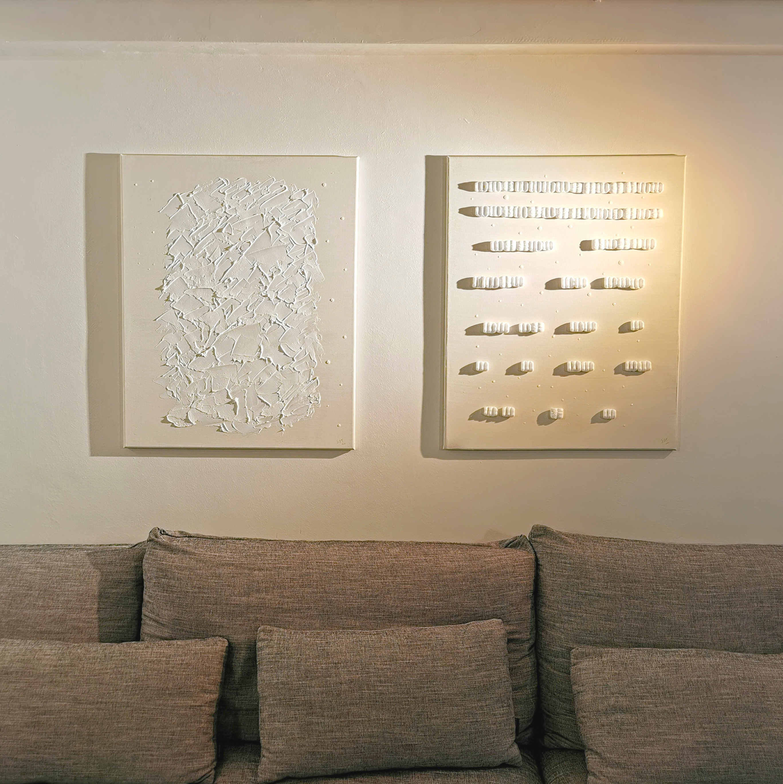 Monochromatic living room with recycled art from our renovation - White abstract art pieces, minimalist design, textured