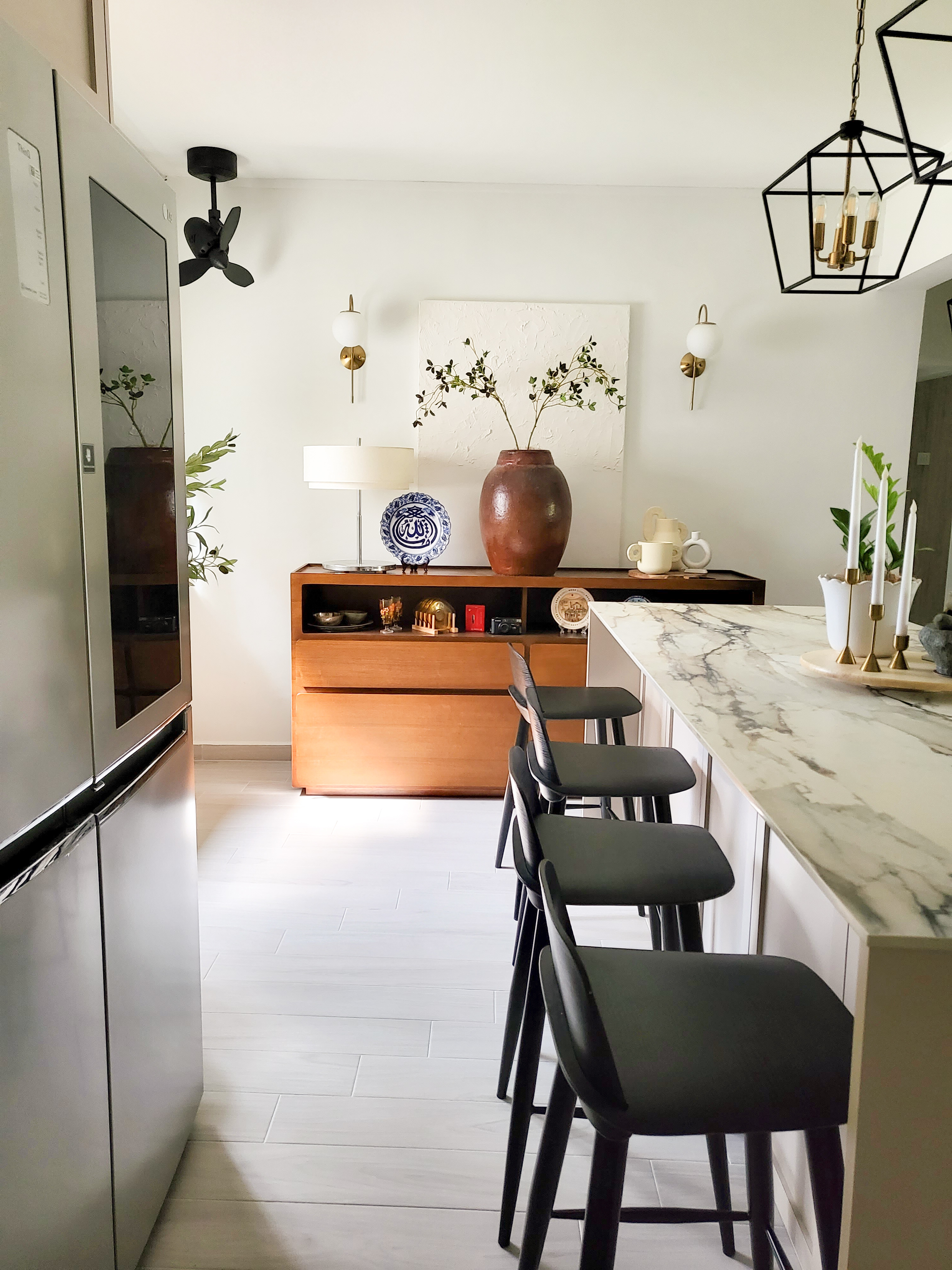 Quaint and Charming Dining Spaces  - Modern kitchen with sleek appliances, minimalist design, white marble countertop, black