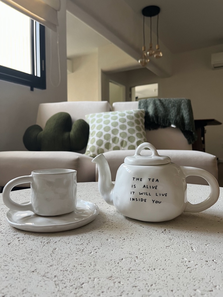 Spicing Up Small Living Spaces  - White ceramic teapot with black text, "The tea is all live it will live inside you, " on a