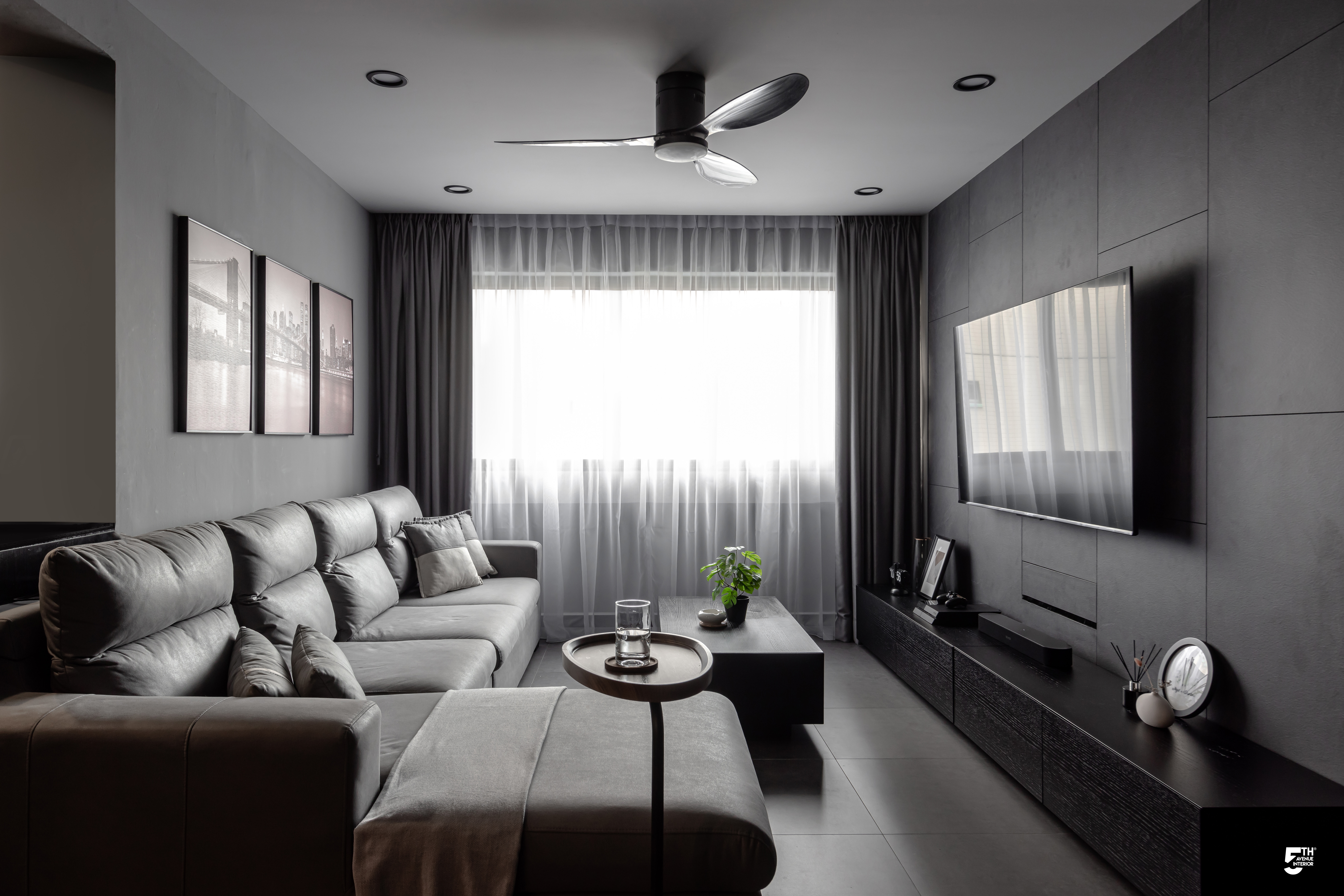 Living Room in Grey - Modern minimalist living room, sleek ceiling fan, large comfortable sofa, soft gray cushions, large