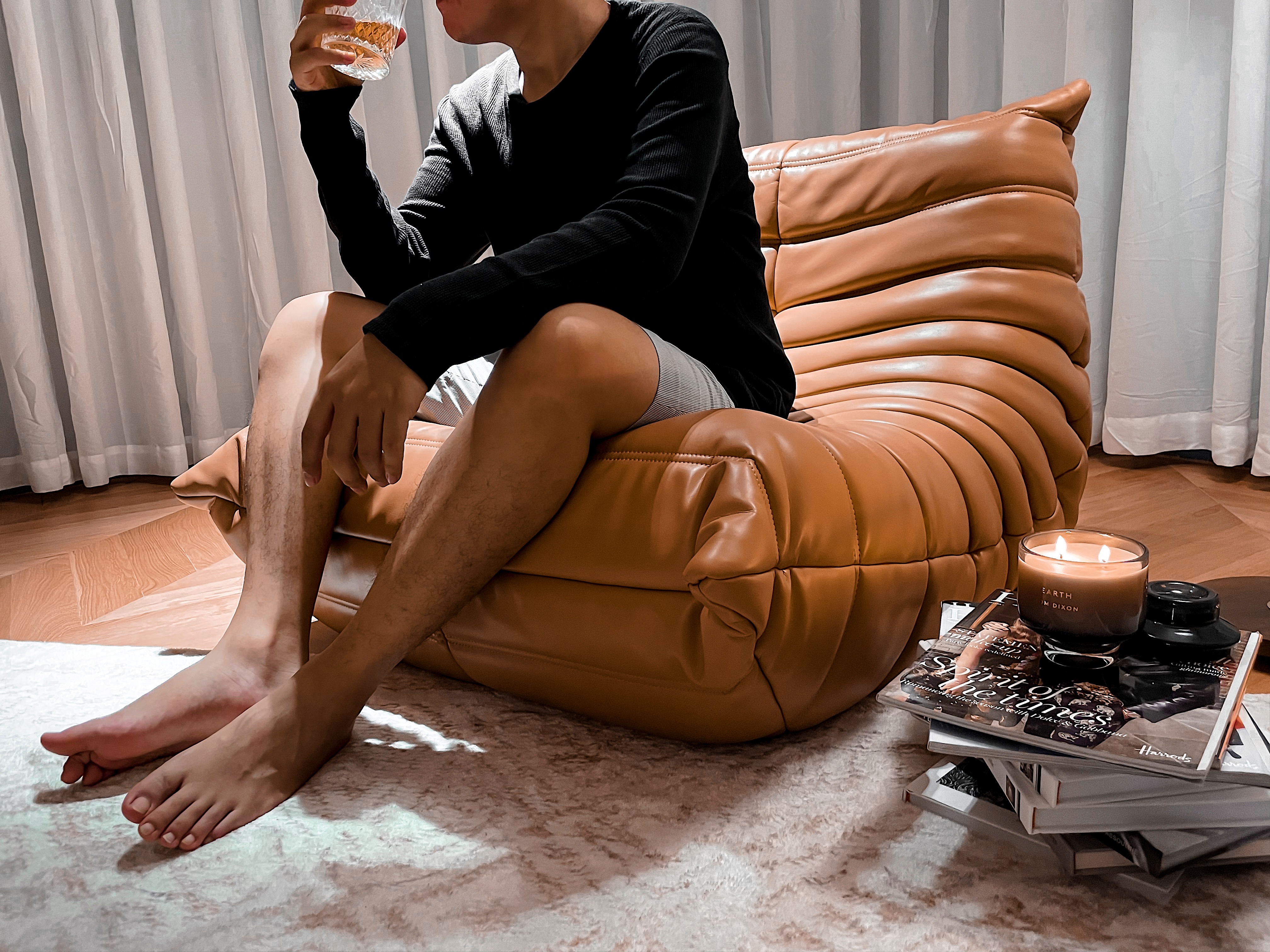 My Cozy Corner: A Place of Serenity and Comfort - Leather couch, man sitting, brown leather, cozy room, indoor setting, soft