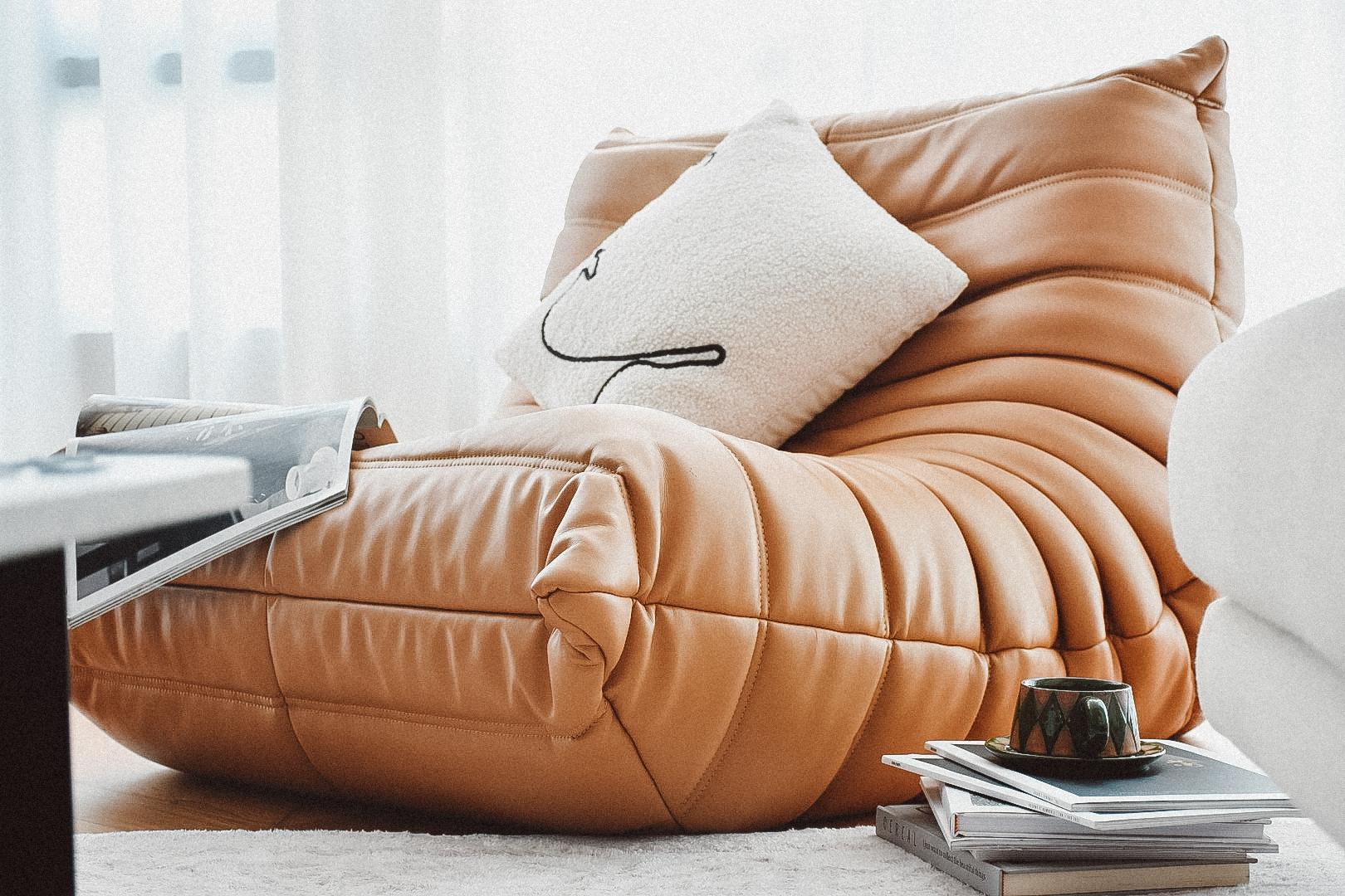 My Cozy Corner: A Place of Serenity and Comfort - Modern cozy lounge chair, plush orange leather, soft cushions, minimalist