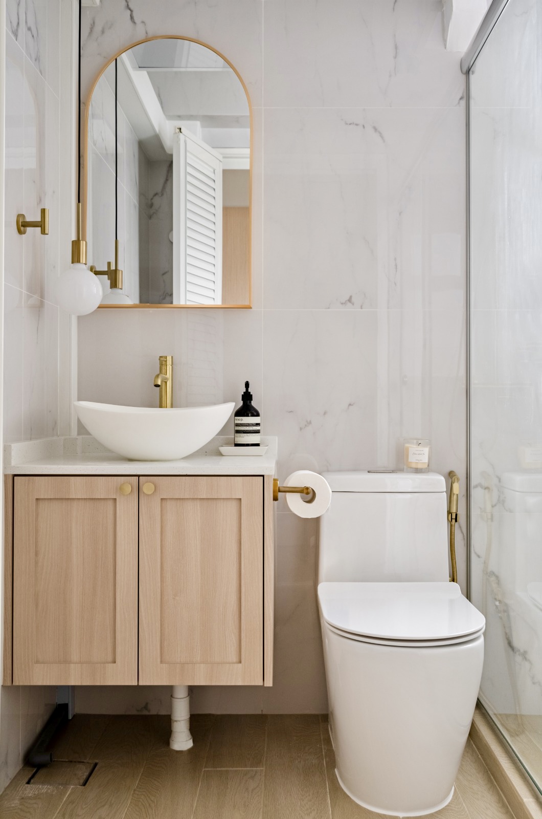 Our Scandi + Treetop Cabin toilets within good budget  - White marble tiles, gold fixtures, wooden vanity, modern sink, gold