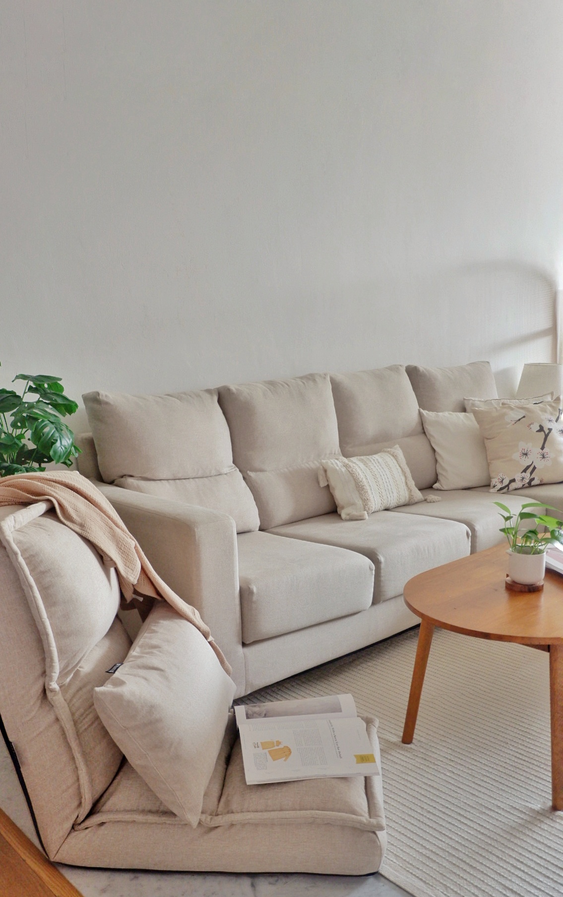 Minimalist Living Room  - Cream-colored sectional sofa, minimalist decor, soft beige cushions, modern living room, cozy