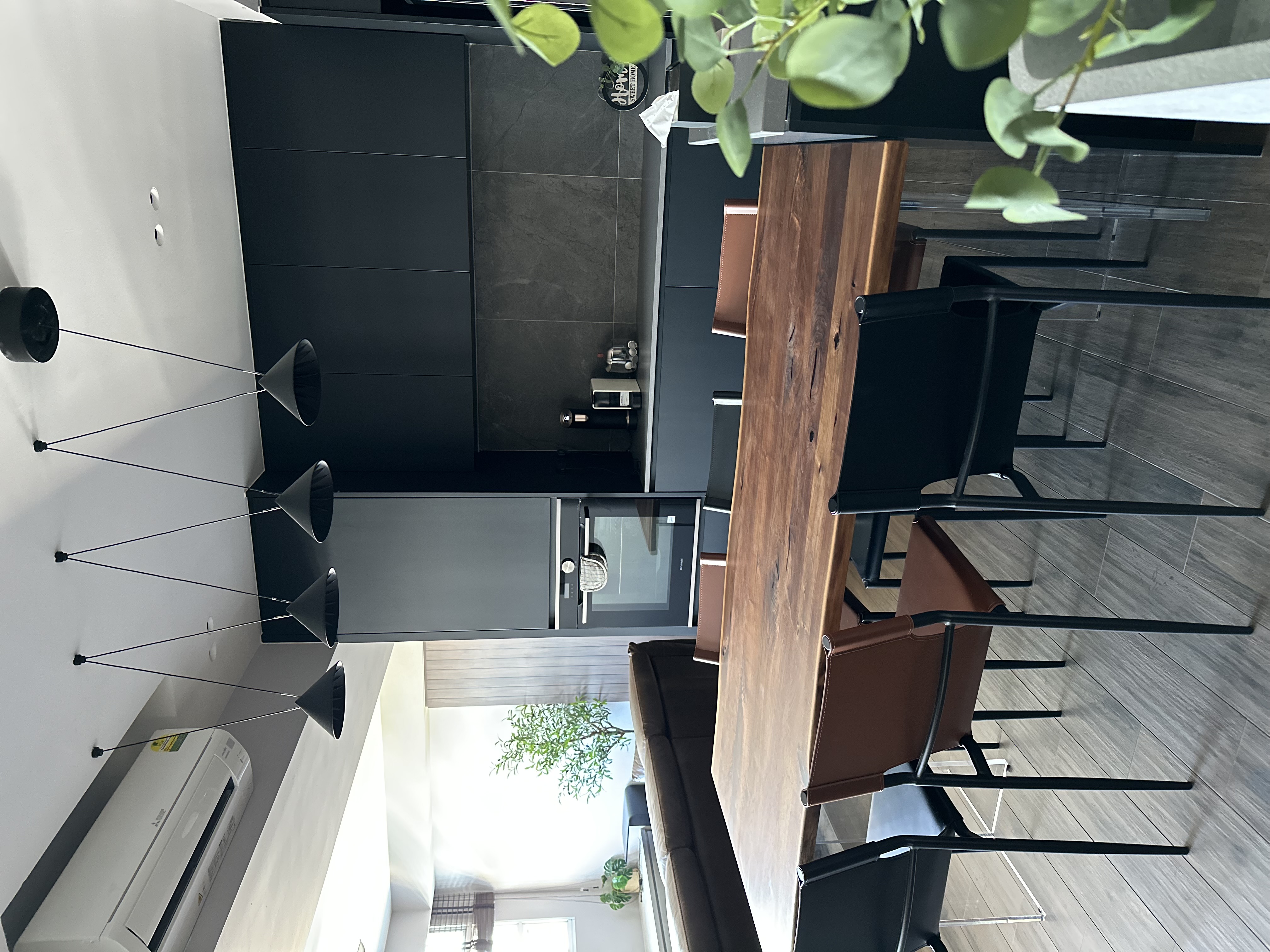 where the eating happens 😋 - Modern minimalist kitchen, sleek furniture, contemporary design, black cabinets, wooden dining