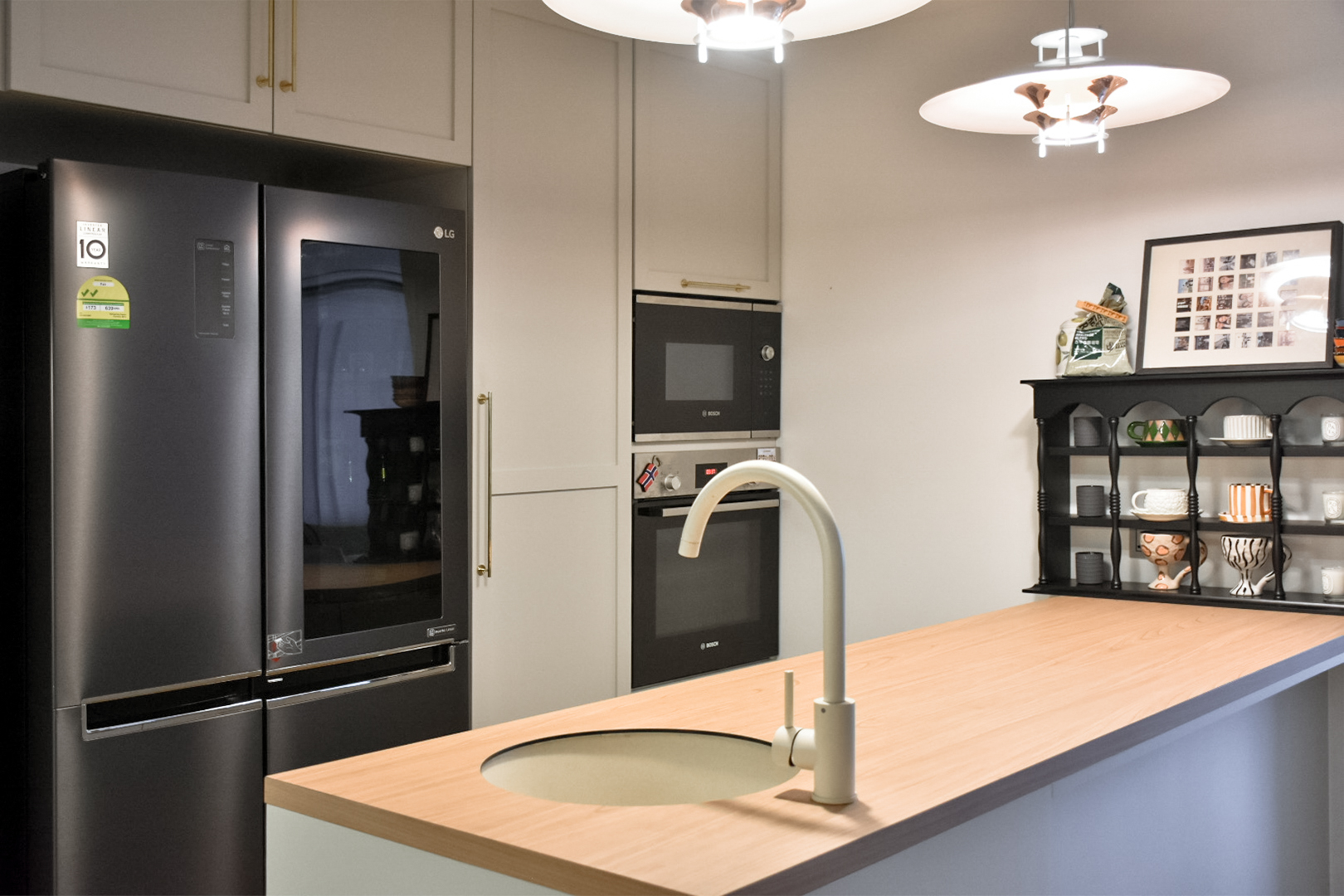 My Kitchen Transformation: From One Space to Two - Modern kitchen with sleek black appliances, including a refrigerator