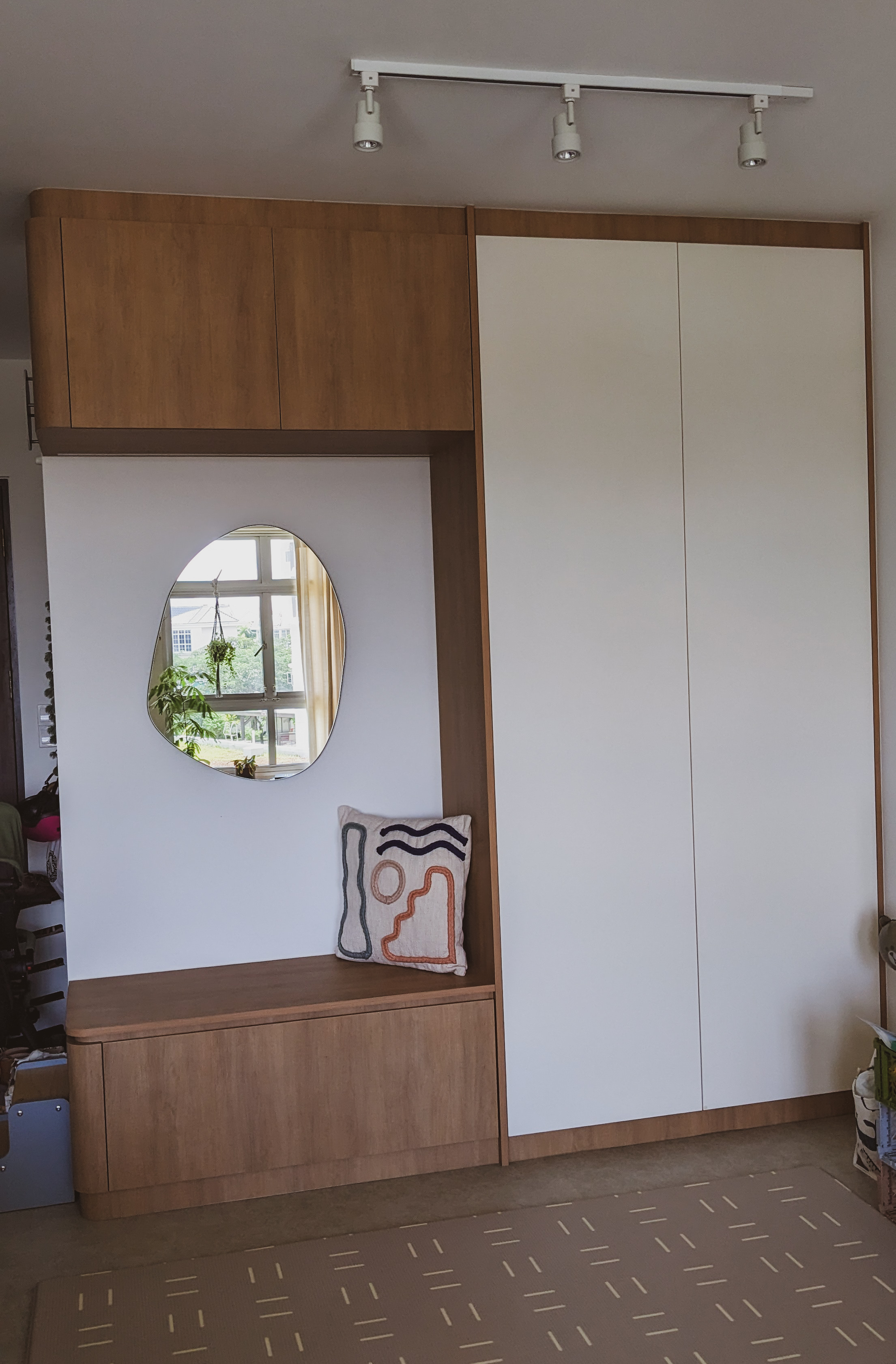 Enter in | Welcoming our Guests - Wooden cabinet, white wall, round mirror, indoor plant, hanging plant, geometric pillow
