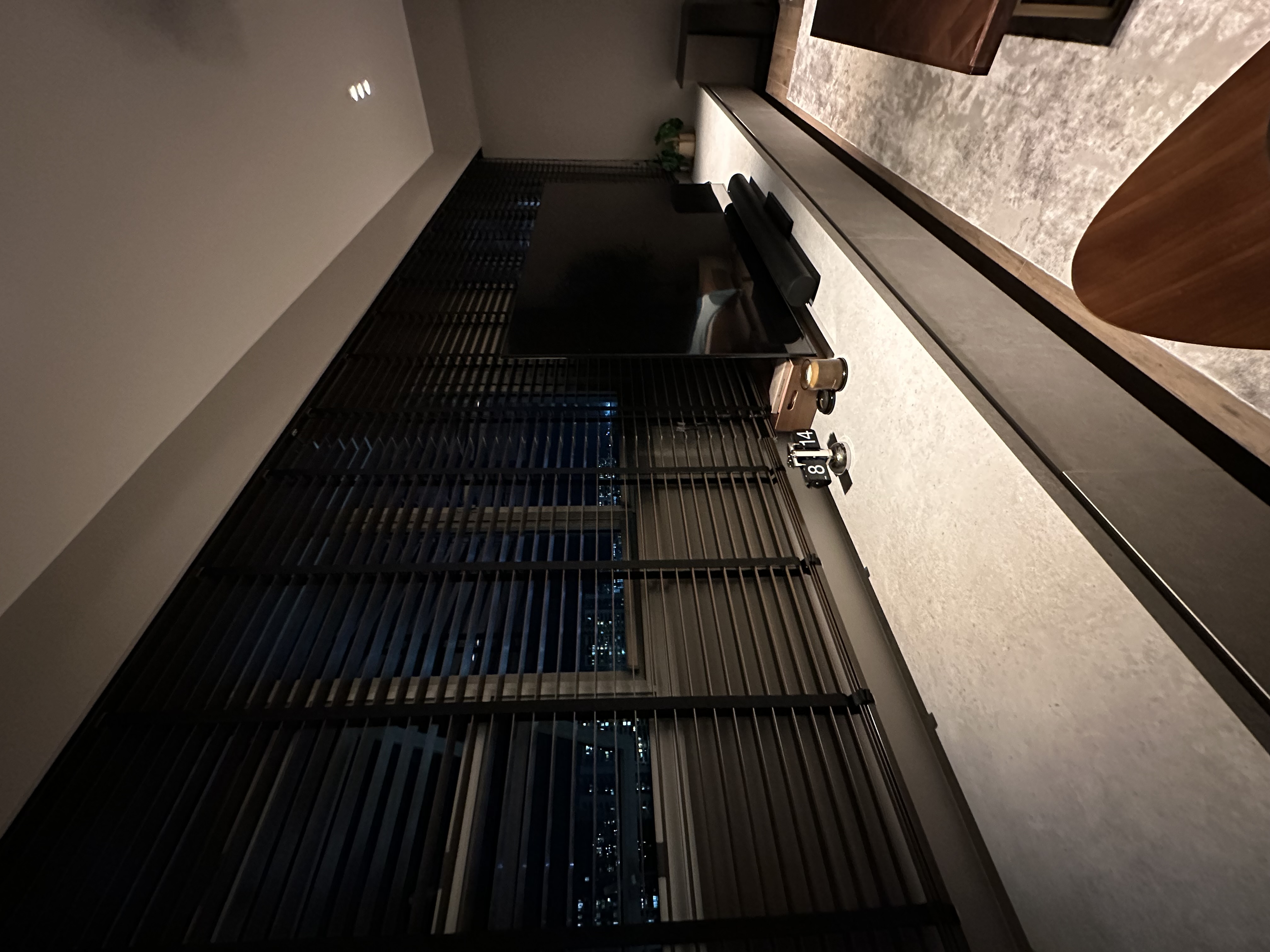 Living area - how we transformed 2 rooms into 1 - Modern apartment interior, nighttime view, large windows, vertical blinds