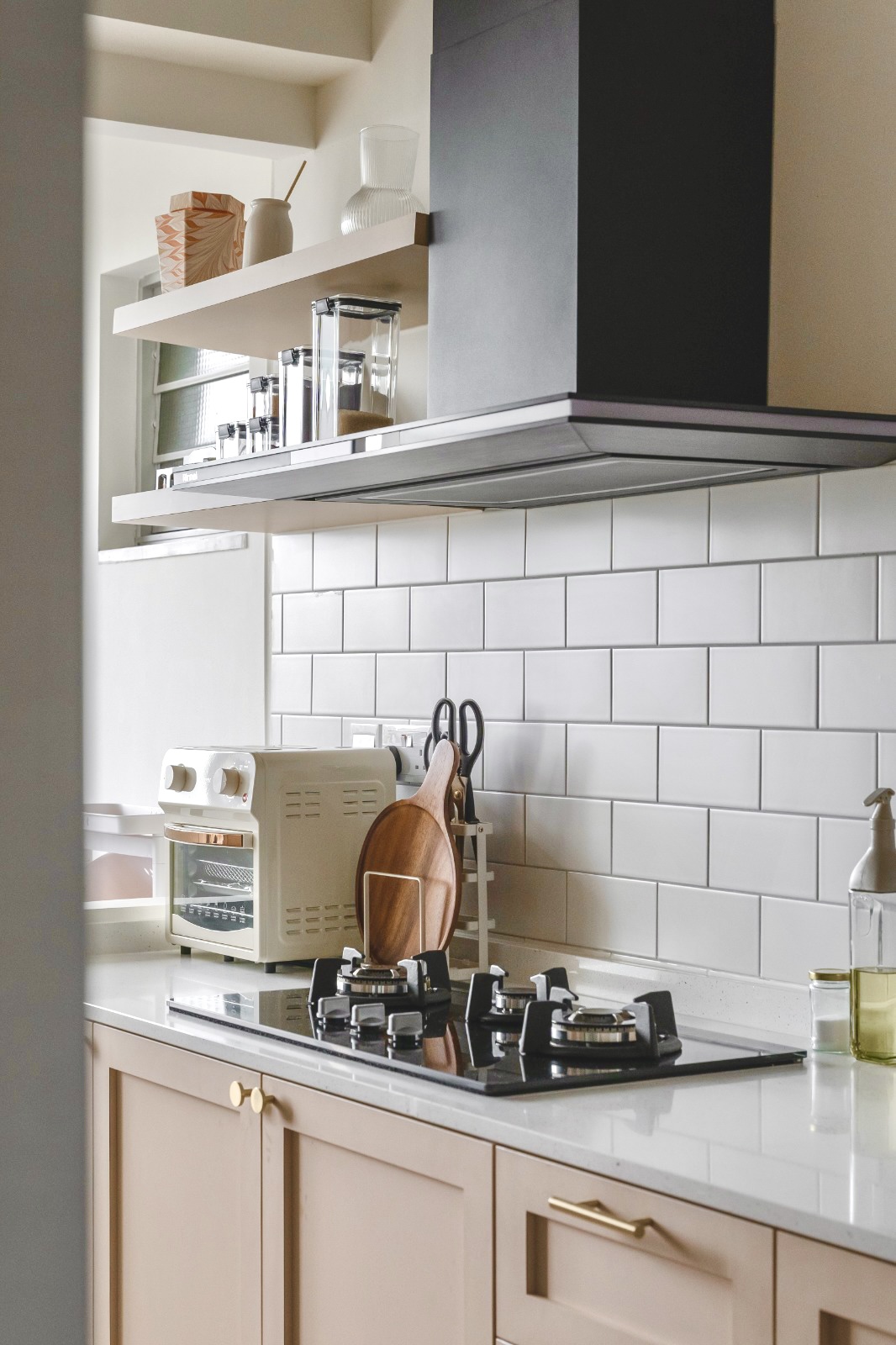 Open-concept modern scandi Kitchen - White kitchen countertop, modern appliances, beige cabinets, black stove, white subway