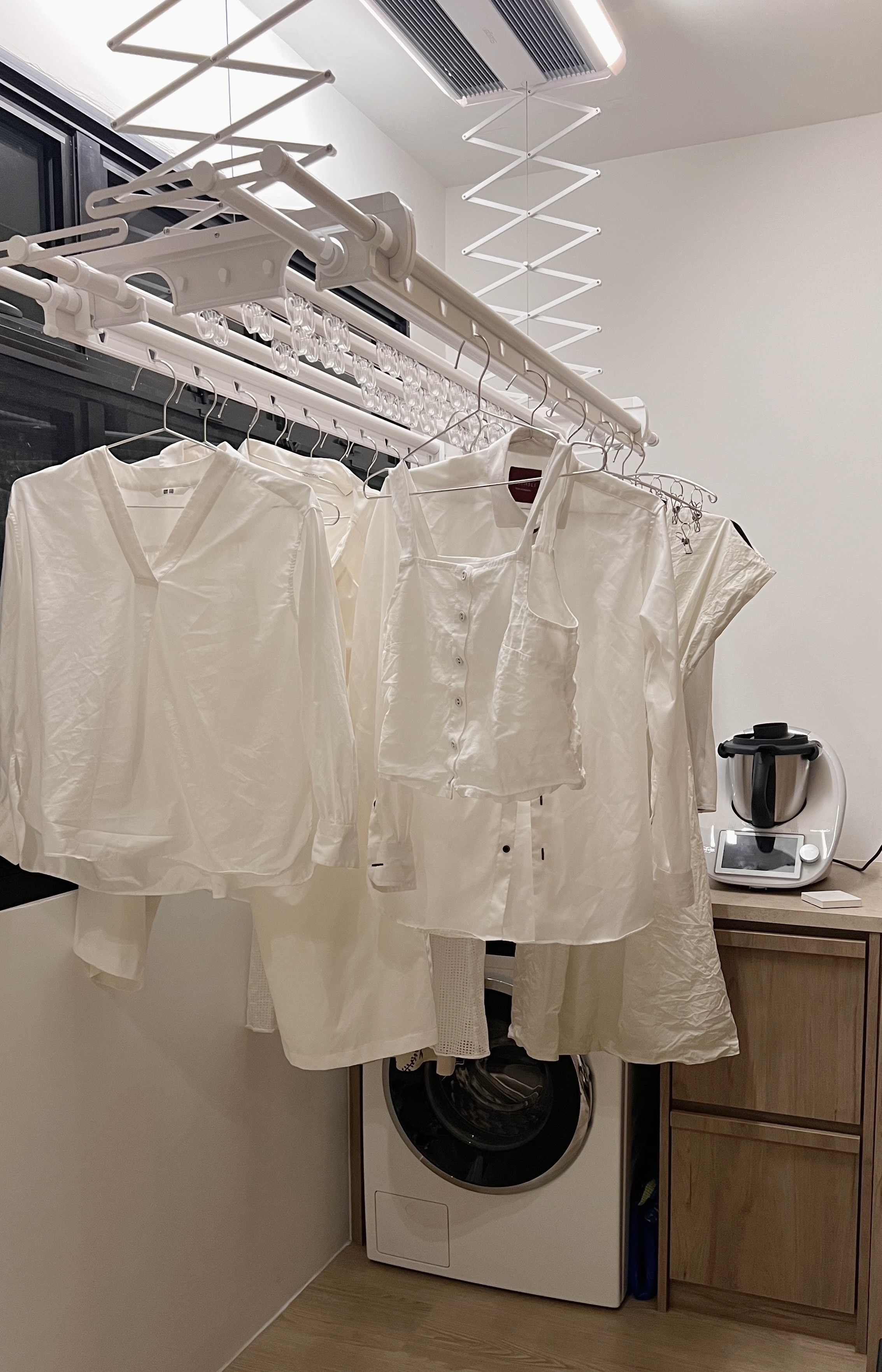 Clean and Fresh: Our Minimalist Laundry Area - White clothing rack, hanging white shirts, modern laundry room, minimalist