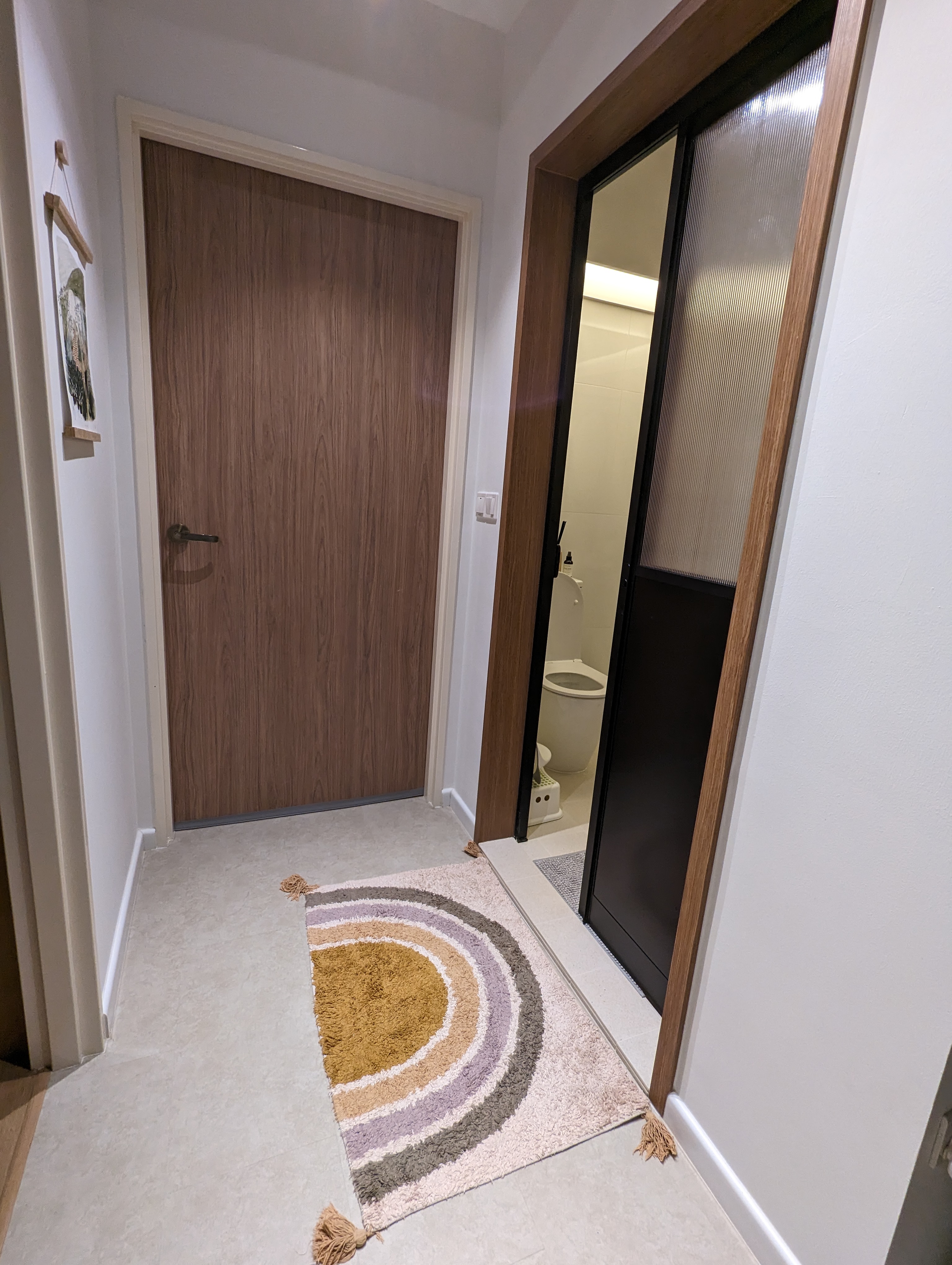 Comfort and Relief | Creating a mood for that ploop - Wooden door, bathroom, toilet, rug, circular pattern, beige, brown