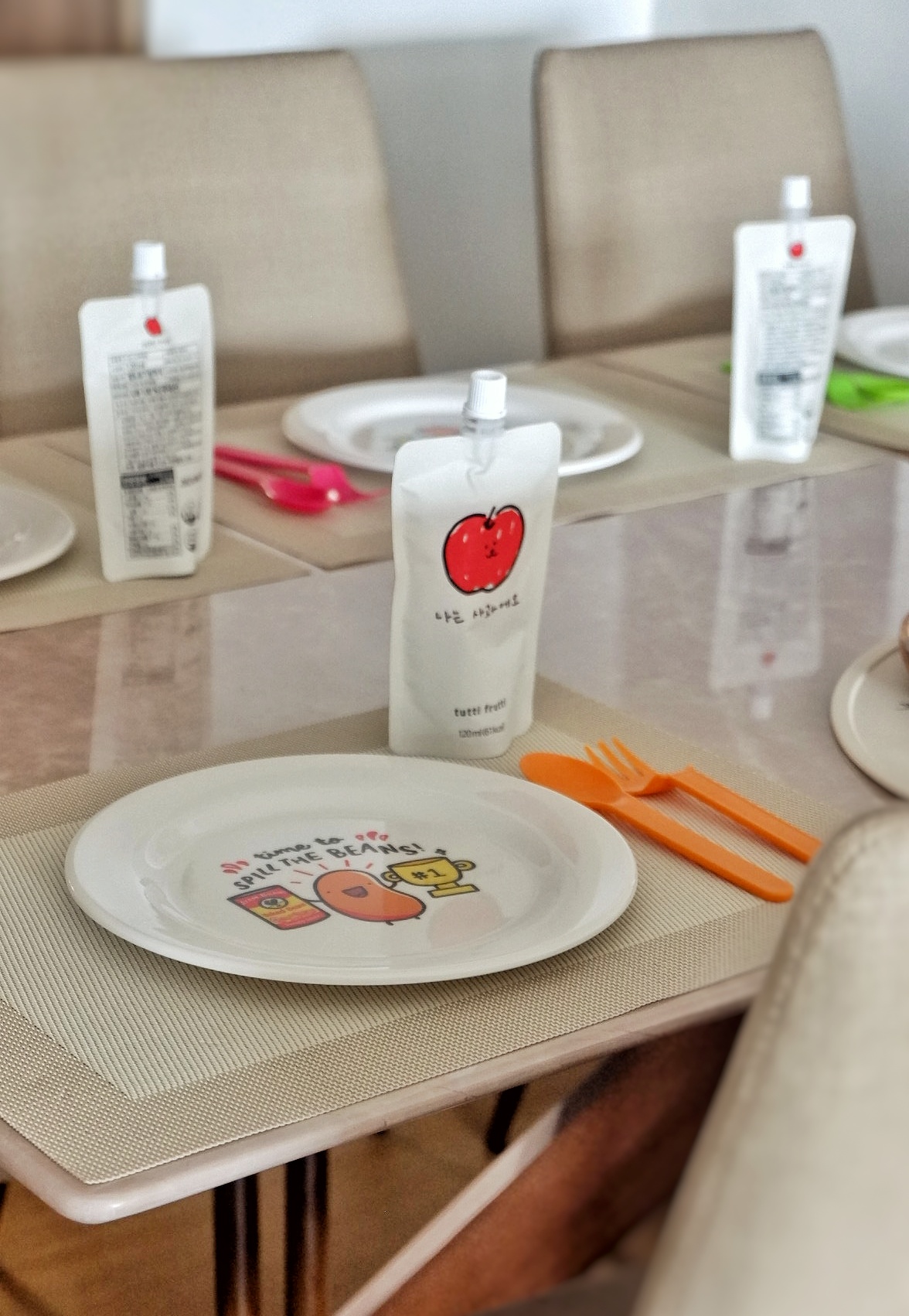 Classy Dining Area For All Things Sumptuous - Table setting, dining table, orange utensils, white plates, cartoon characters