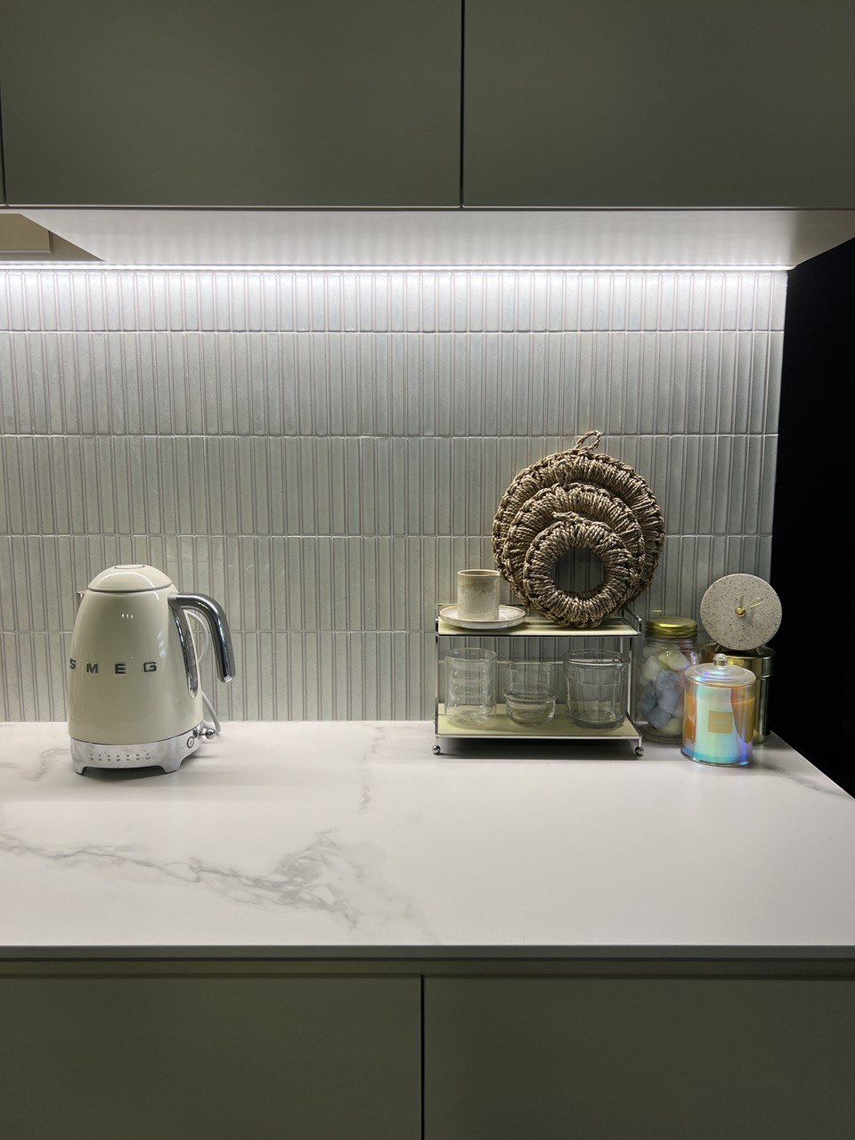 Where the wife spends most of her time at (her love for cooking). - White electric kettle, minimalist kitchen, marble