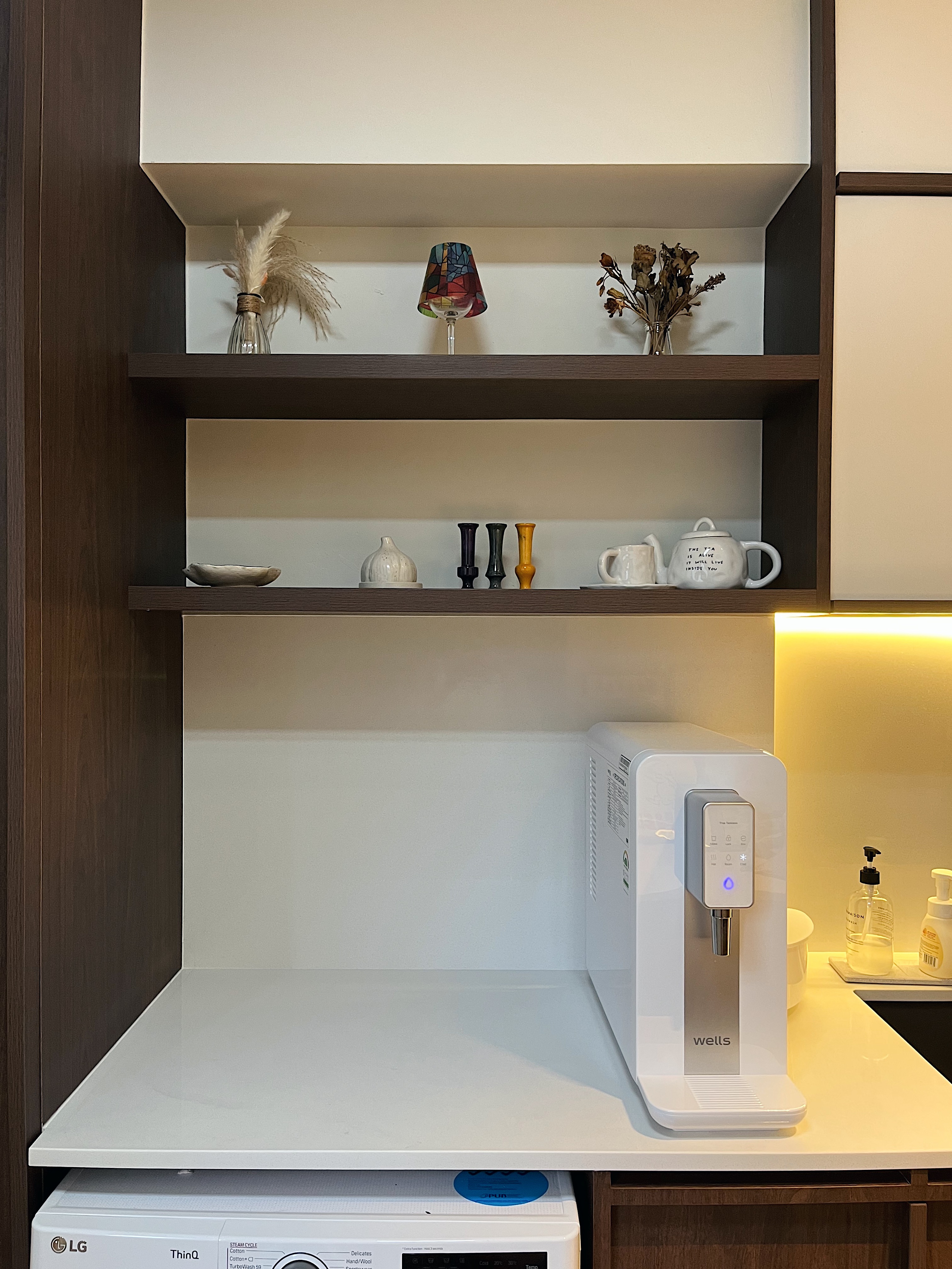Small Yet Functional Service Yard  - Shelf with decorative items, white LG washing machine, water dispenser, modern kitchen