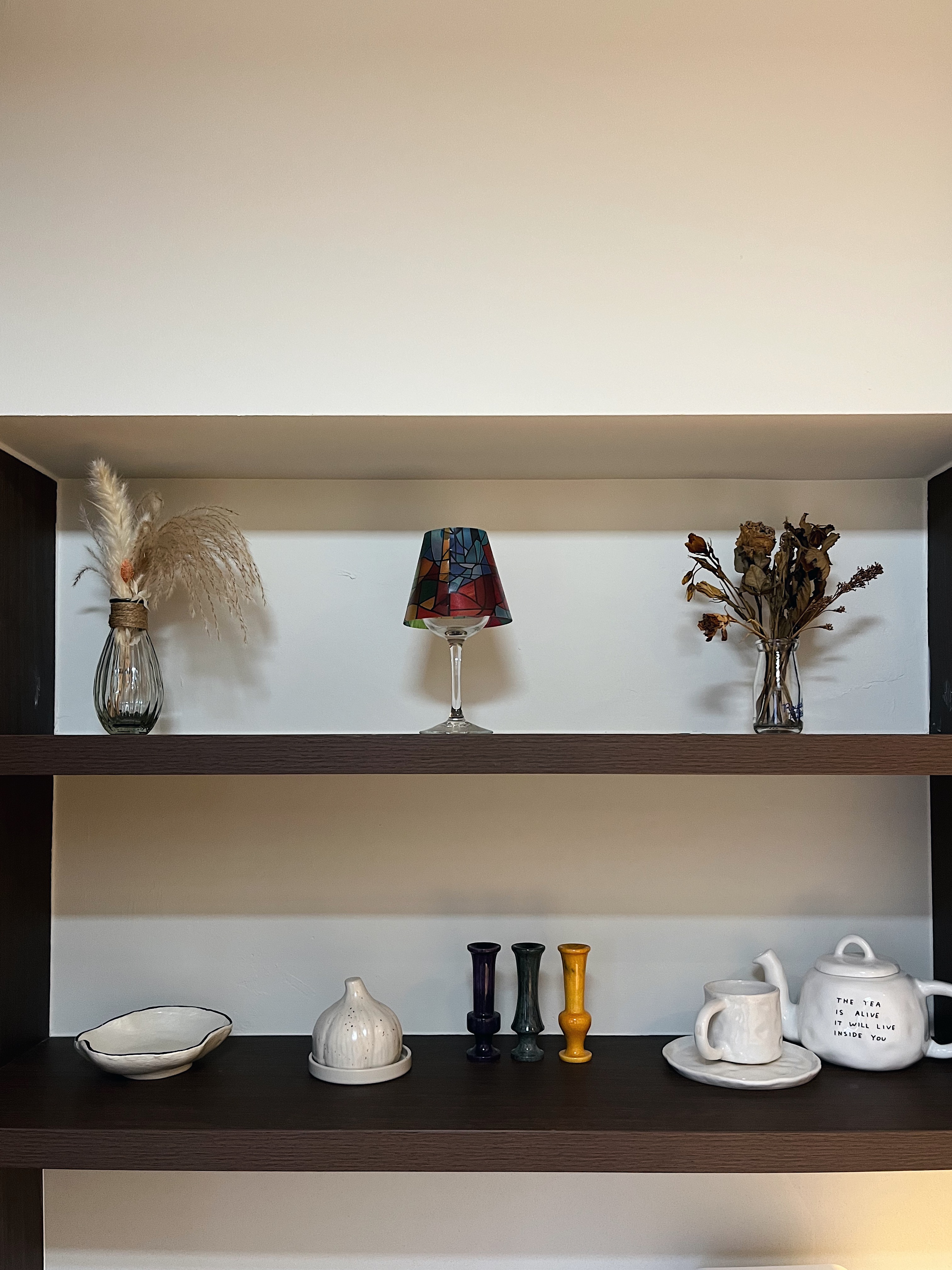 Small Yet Functional Service Yard  - vase with feathers, colorful lampshade, dried flowers, ceramic bowl, white teapot, white