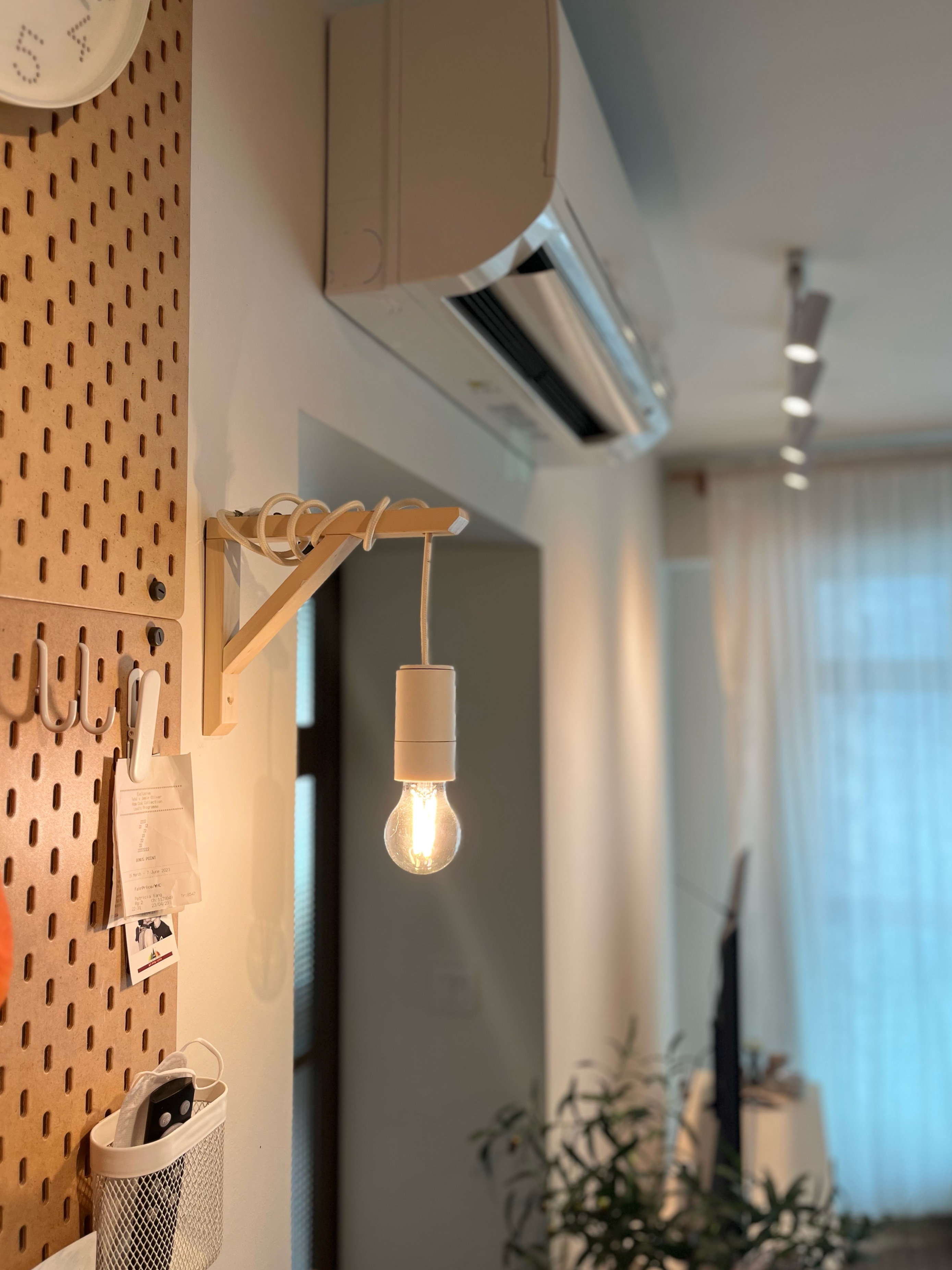 Living Room: Netflix, chill, fall asleep till 3am - Dusty wall, corkboard, hanging light bulb, office supplies, whiteboard