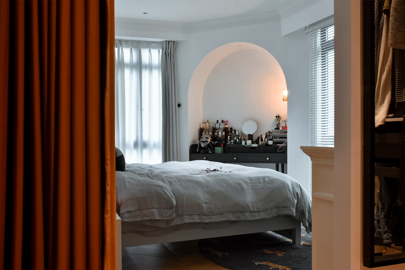 From Ordinary to Extraordinary: Our Master Bedroom Makeover - Orange curtains frame the view, soft light filters through