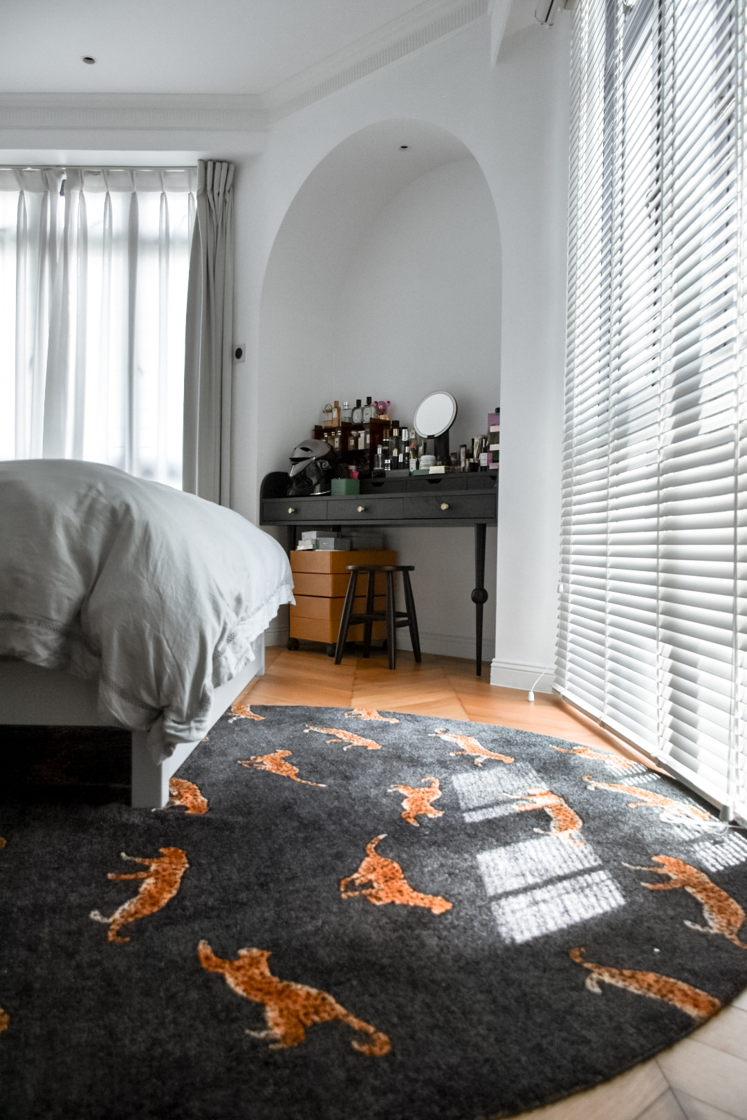From Ordinary to Extraordinary: Our Master Bedroom Makeover - White bedroom with neatly made bed, gray and orange patterned