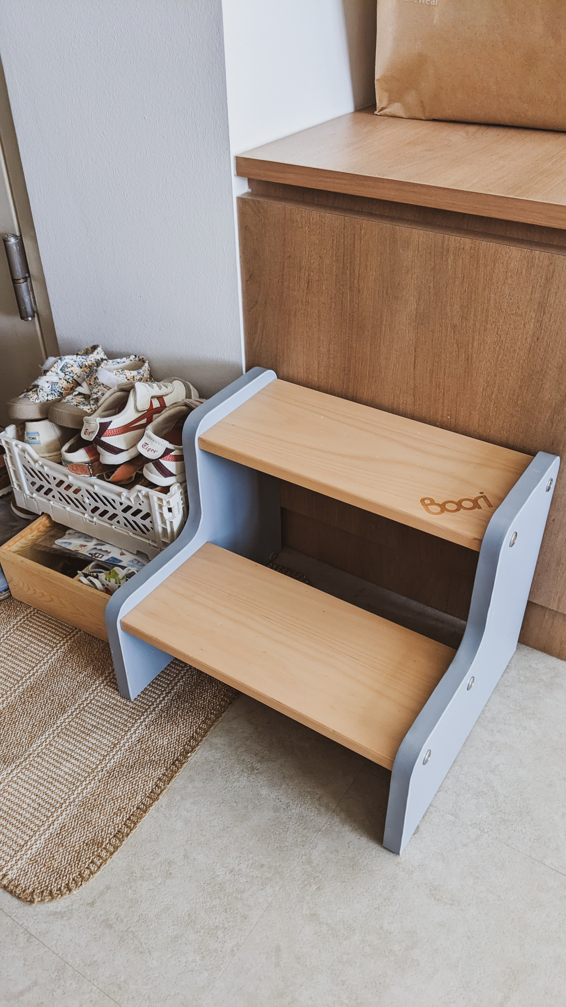 A Canvas for Imagination | Space for play and creativity - Wooden step stool with blue metal frame, wooden shelf with "booi"
