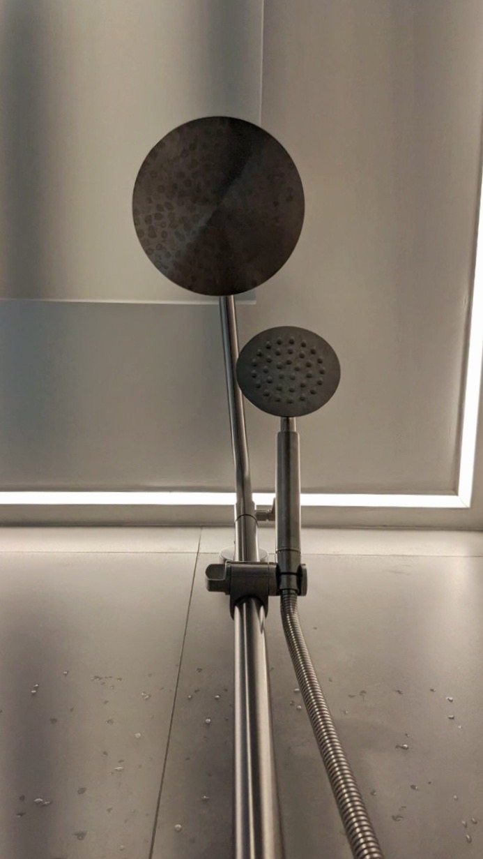 12 Bathroom Renovation Tips We Learned - Modern showerhead, sleek design, metallic finish, dual shower heads, diffuser