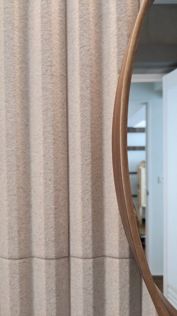 12 Bathroom Renovation Tips We Learned - Curved mirror, wooden frame, textured fabric, vertical stripes, modern design