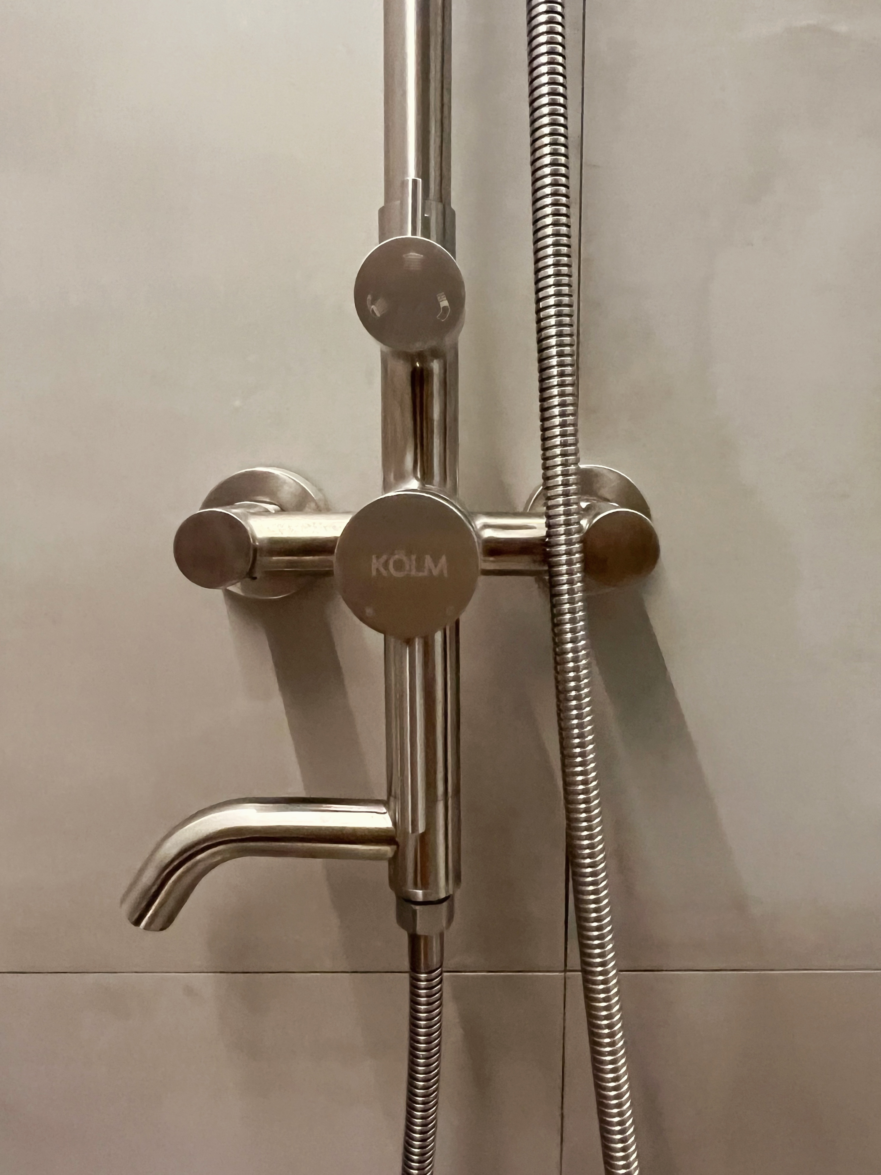 12 Bathroom Renovation Tips We Learned - shower head, chrome finish, KOLM logo, metallic design, dual controls, flexible