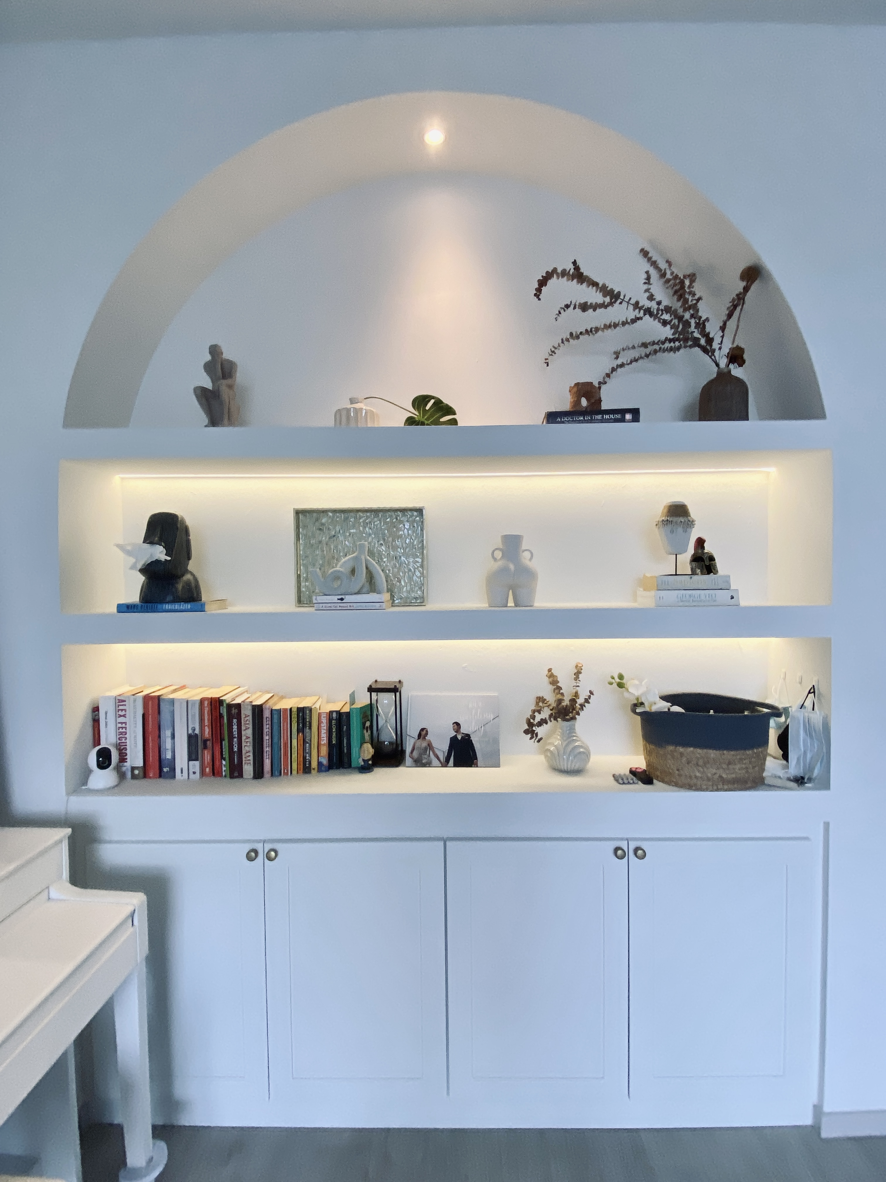 Cozy corner with our favourite things  - White arched shelving unit, minimalist decor, modern art pieces, books, decorative