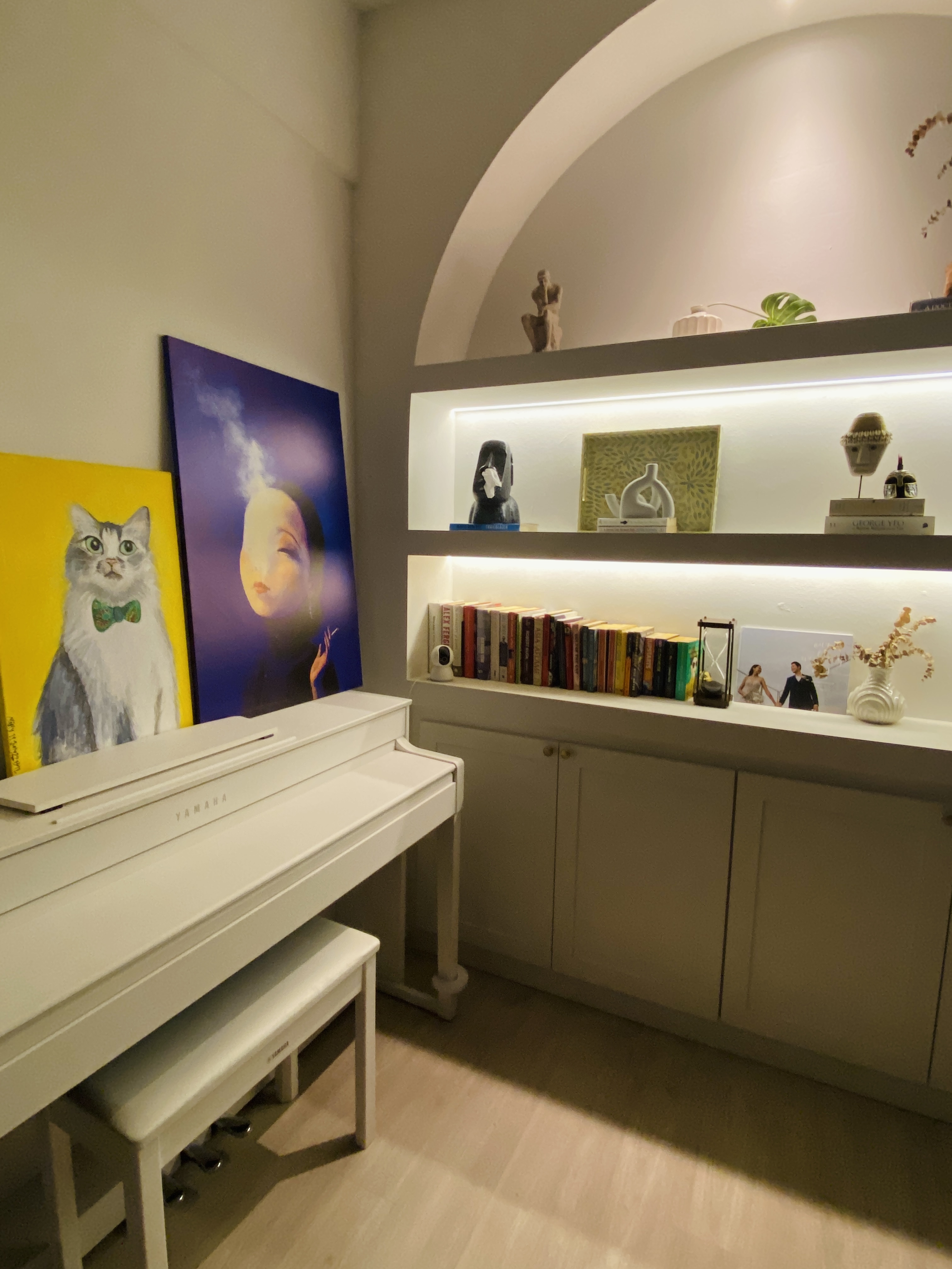 Cozy corner with our favourite things  - White Yamaha piano, minimalist decor, yellow cat painting, blue and purple artwork