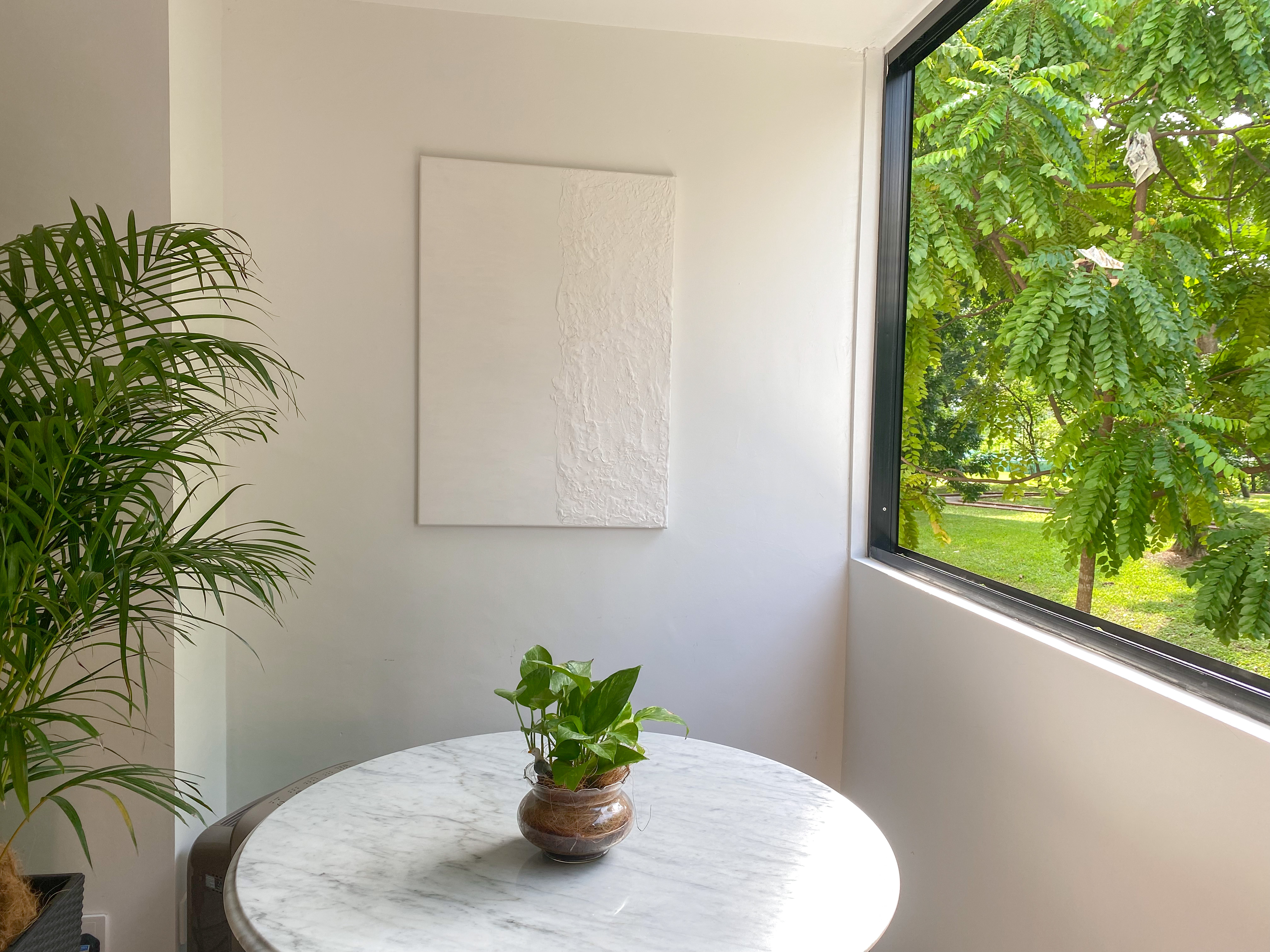 The Best of Bright & Airy Balcony Spaces to Rest and Relax - White wall, indoor setting, modern decor, green plants, abstract