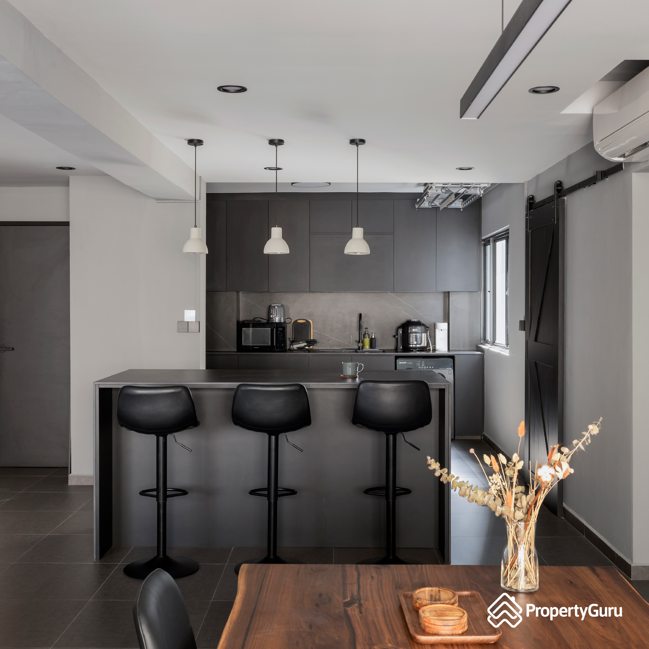 Our laundry area (it's just a corner) - Modern minimalist kitchen, sleek cabinetry, pendant lights, black bar stools, wooden