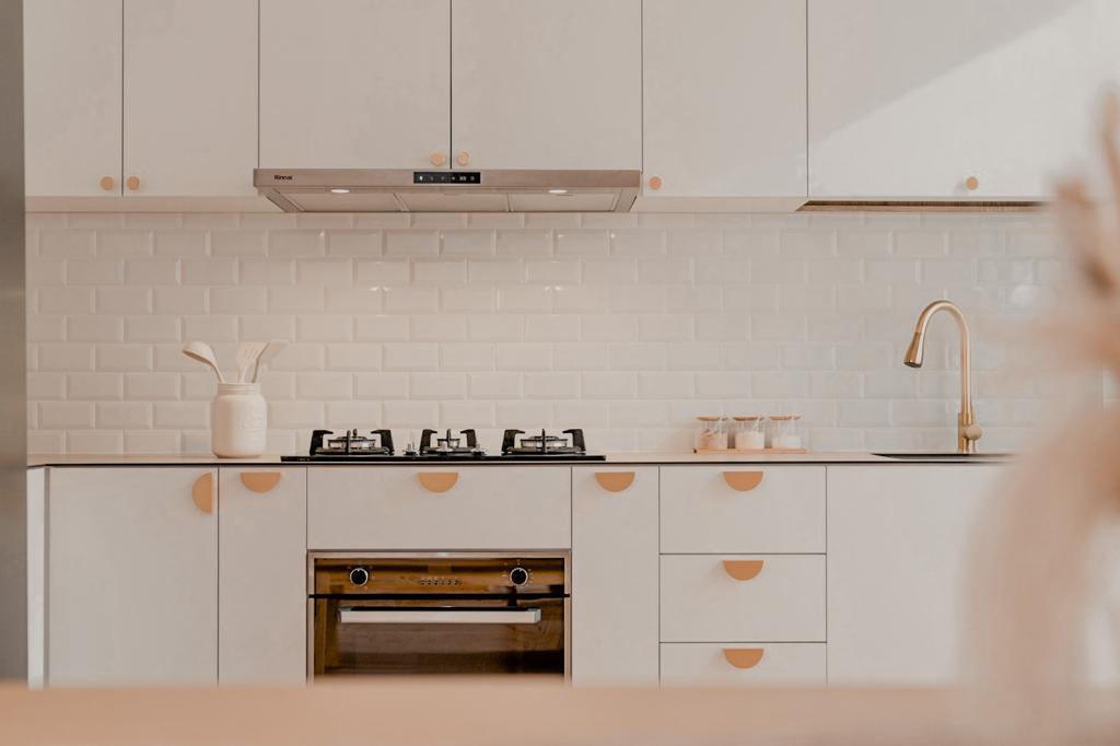 A Simple Kitchen For All Your Possible Needs  - White kitchen cabinetry, stainless steel range hood, white subway tile