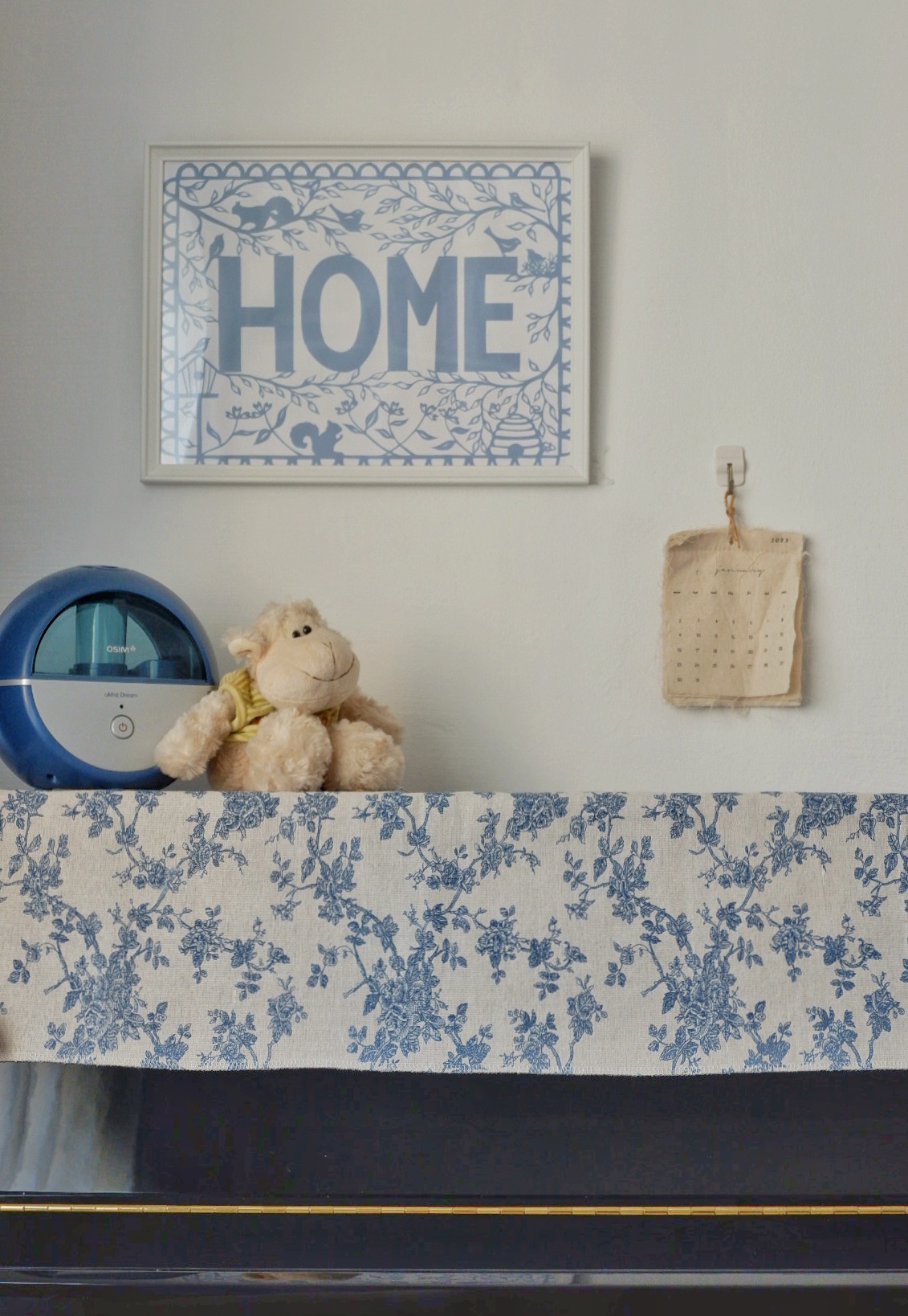 A Room Where Music Comes Alive  - blue and white floral pattern, framed "HOME" sign, plush toy, blue and white floral