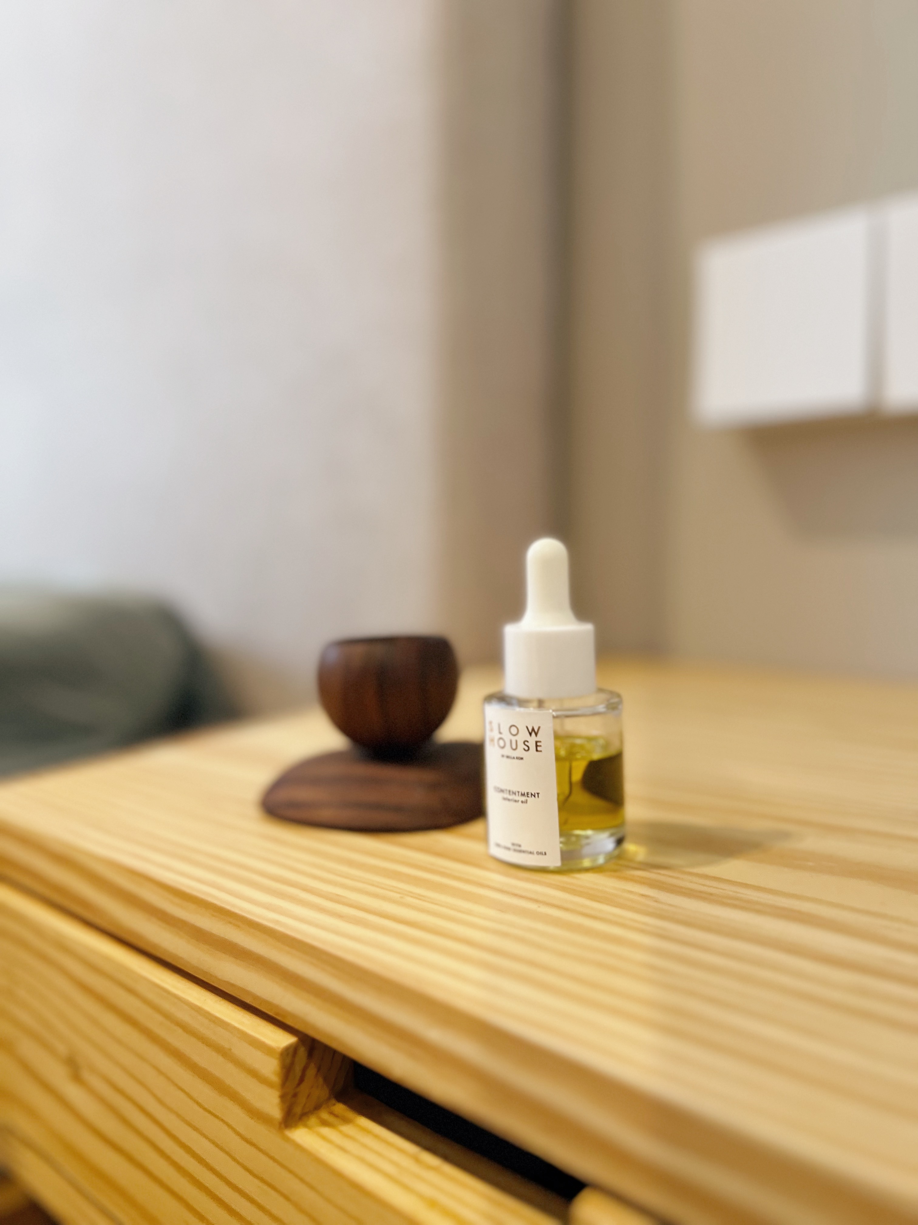 Calmness defined: Our minimalist bedroom sanctuary  - Slow House, Contentment, Wooden bowl, Wooden table, Fragrance bottle