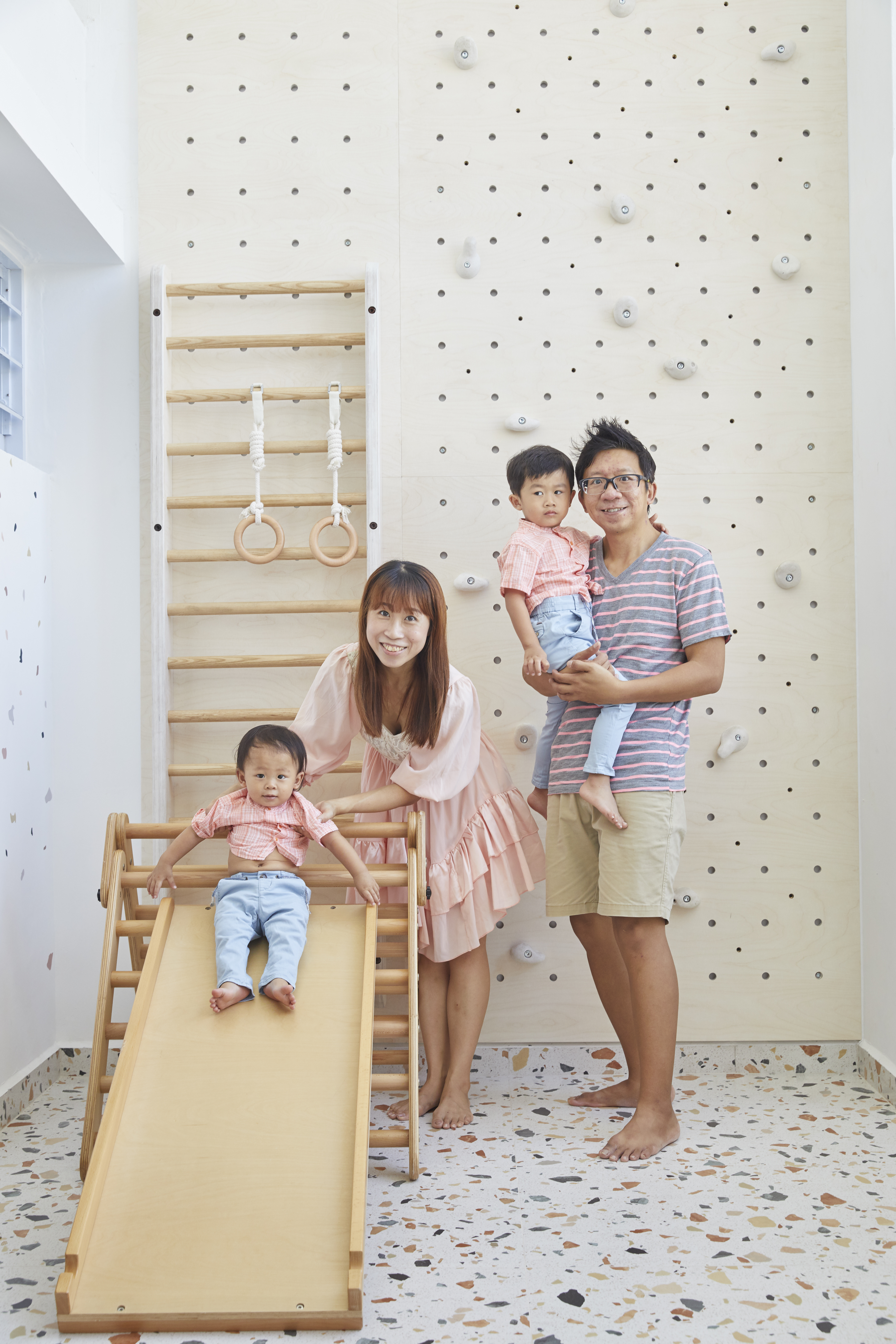 Create an “indoor” open concept play corner  - Family moment, indoor playroom, wooden climbing wall, baby in pink shirt