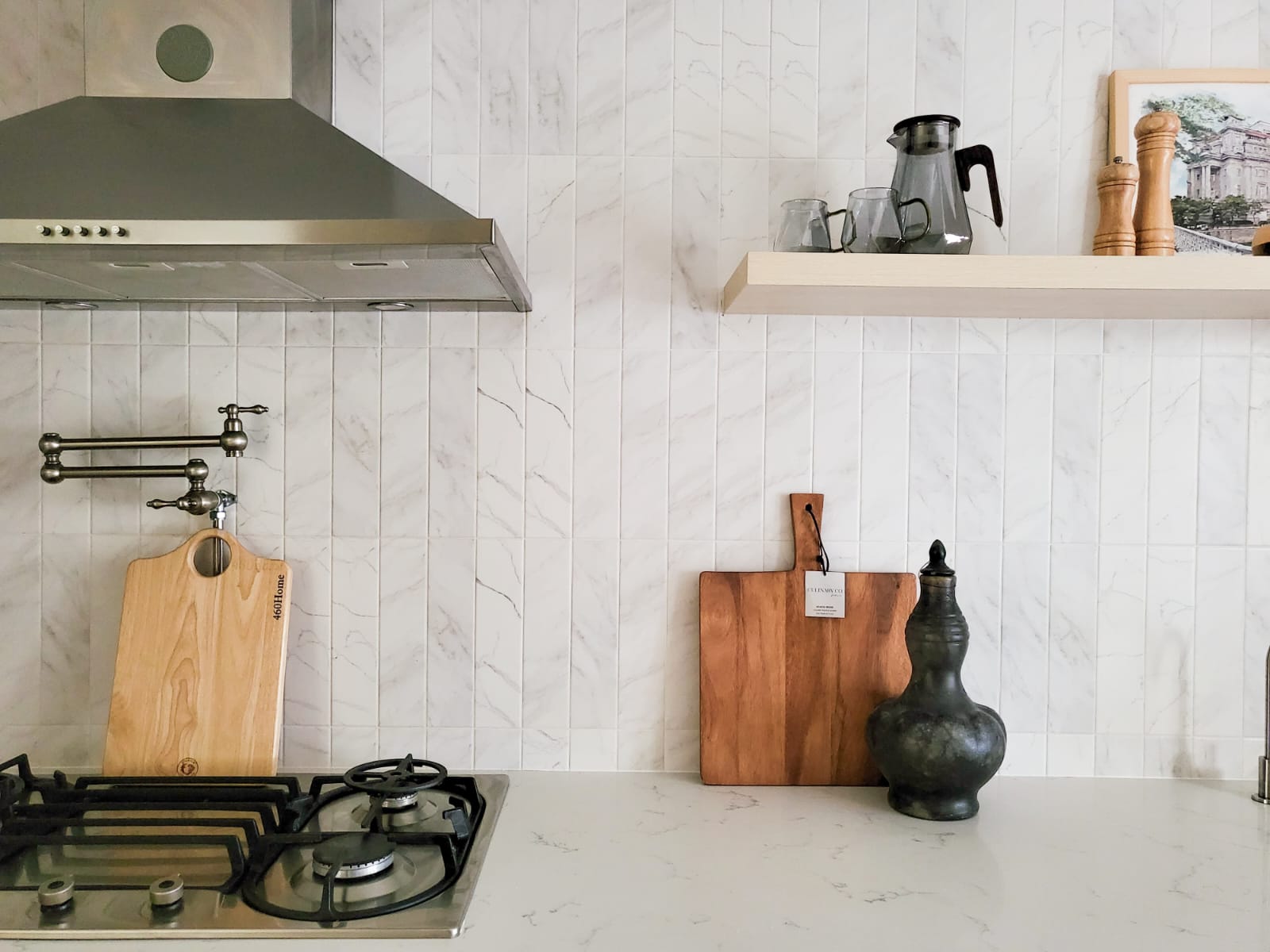 Combining the best of Kitchen Spaces and the English Countryside  - Stainless steel range hood, marble backsplash, wooden